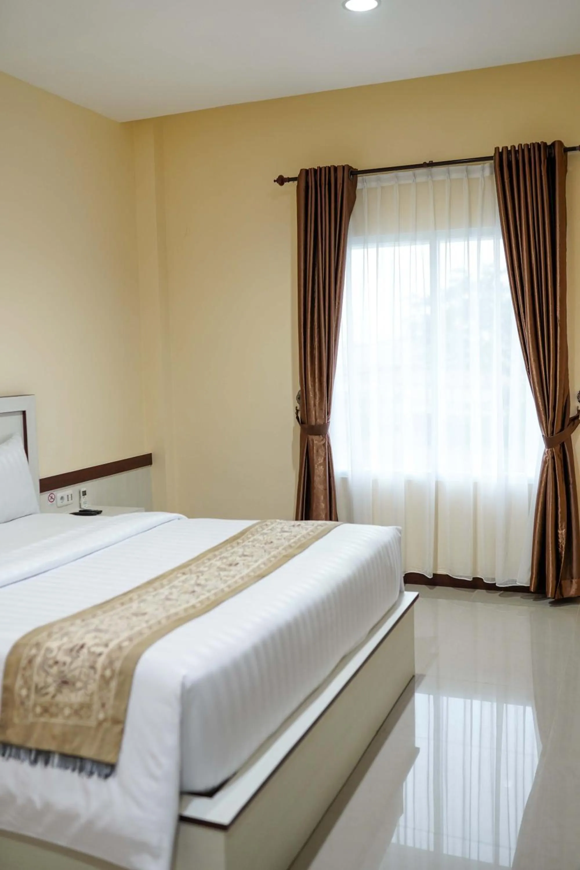 Bed in Grand Buana Lestari Hotel