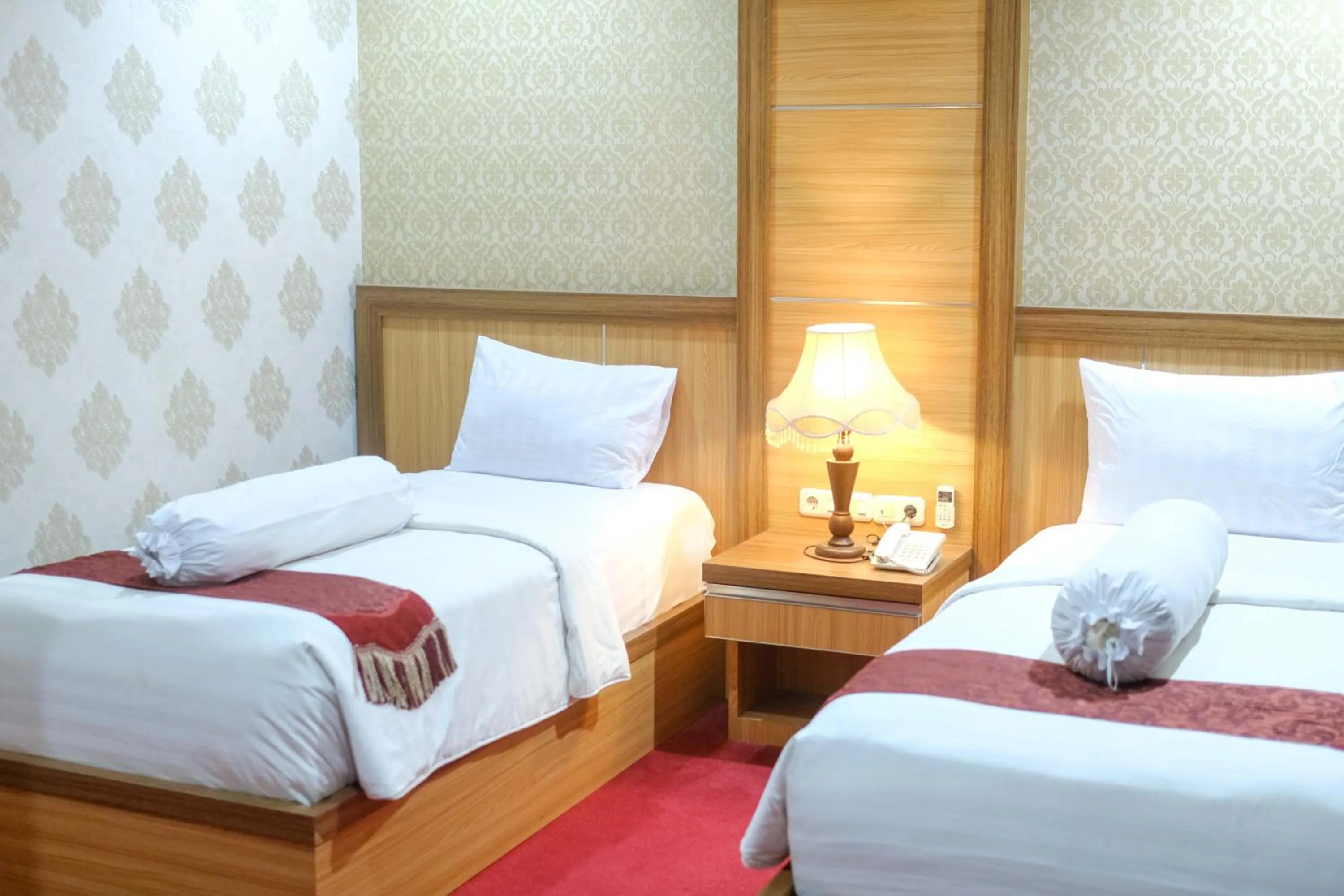 Bed in Grand Buana Lestari Hotel
