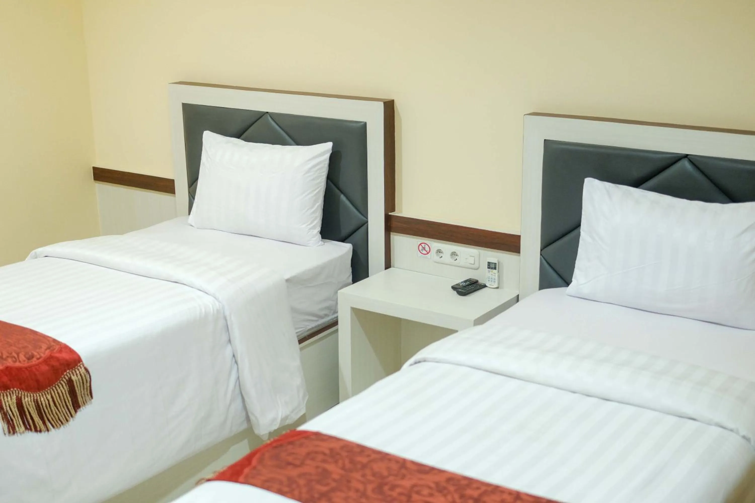 Bed in Grand Buana Lestari Hotel