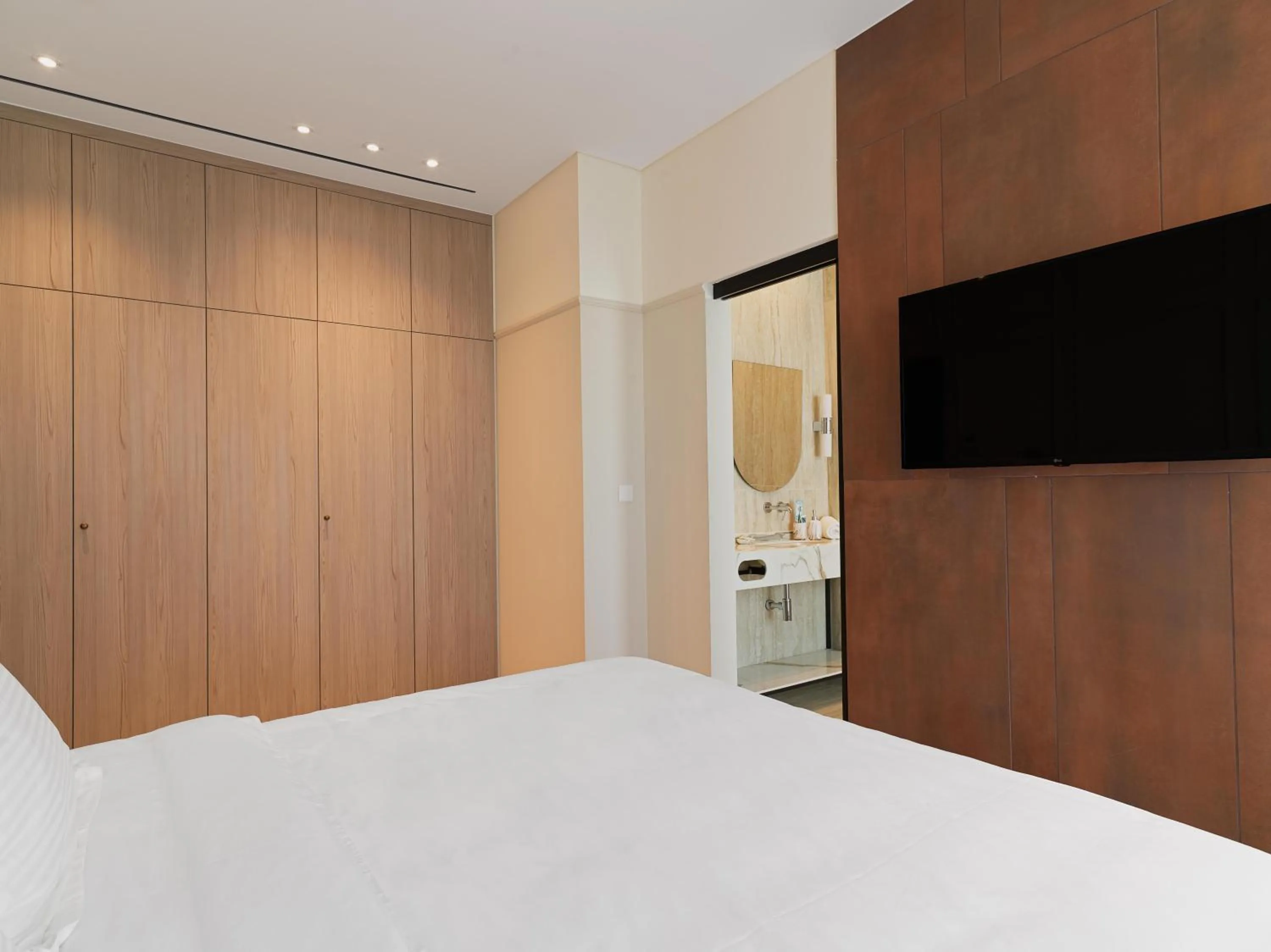 Bathroom, Bed in LIV Mackenzie Beach Suites Larnaca ADULTS ONLY