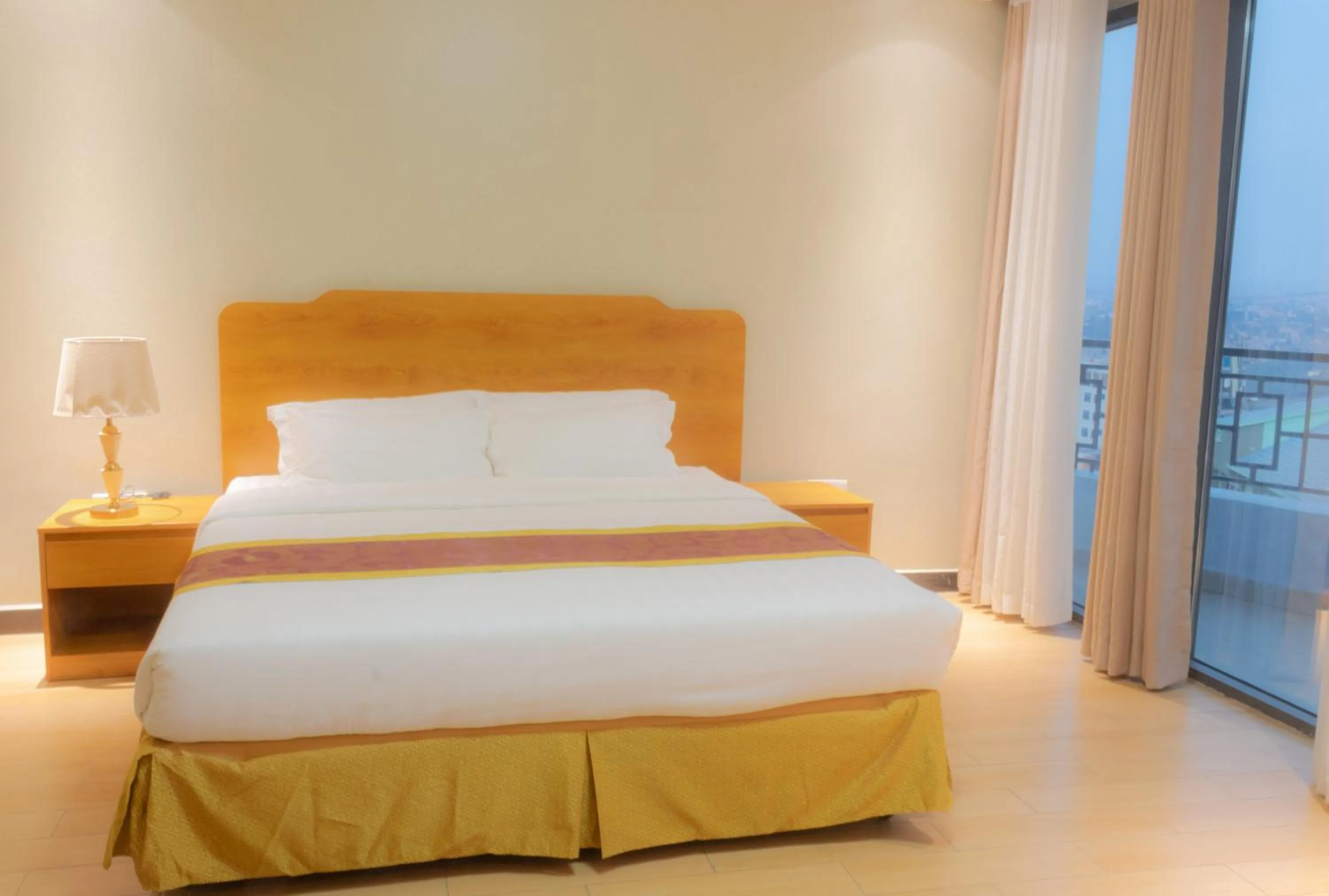 Bed in Tropical Plaza Apartments