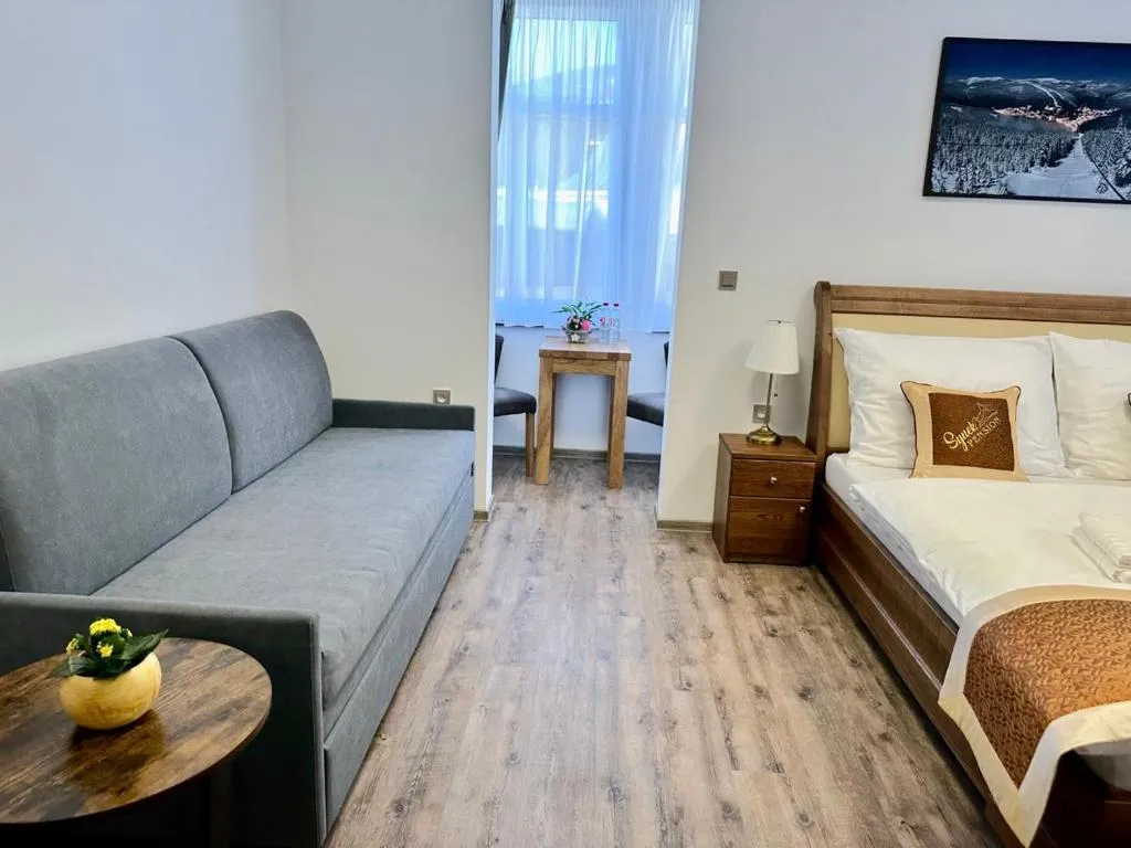 Seating area, Bed in SYNEK Pension