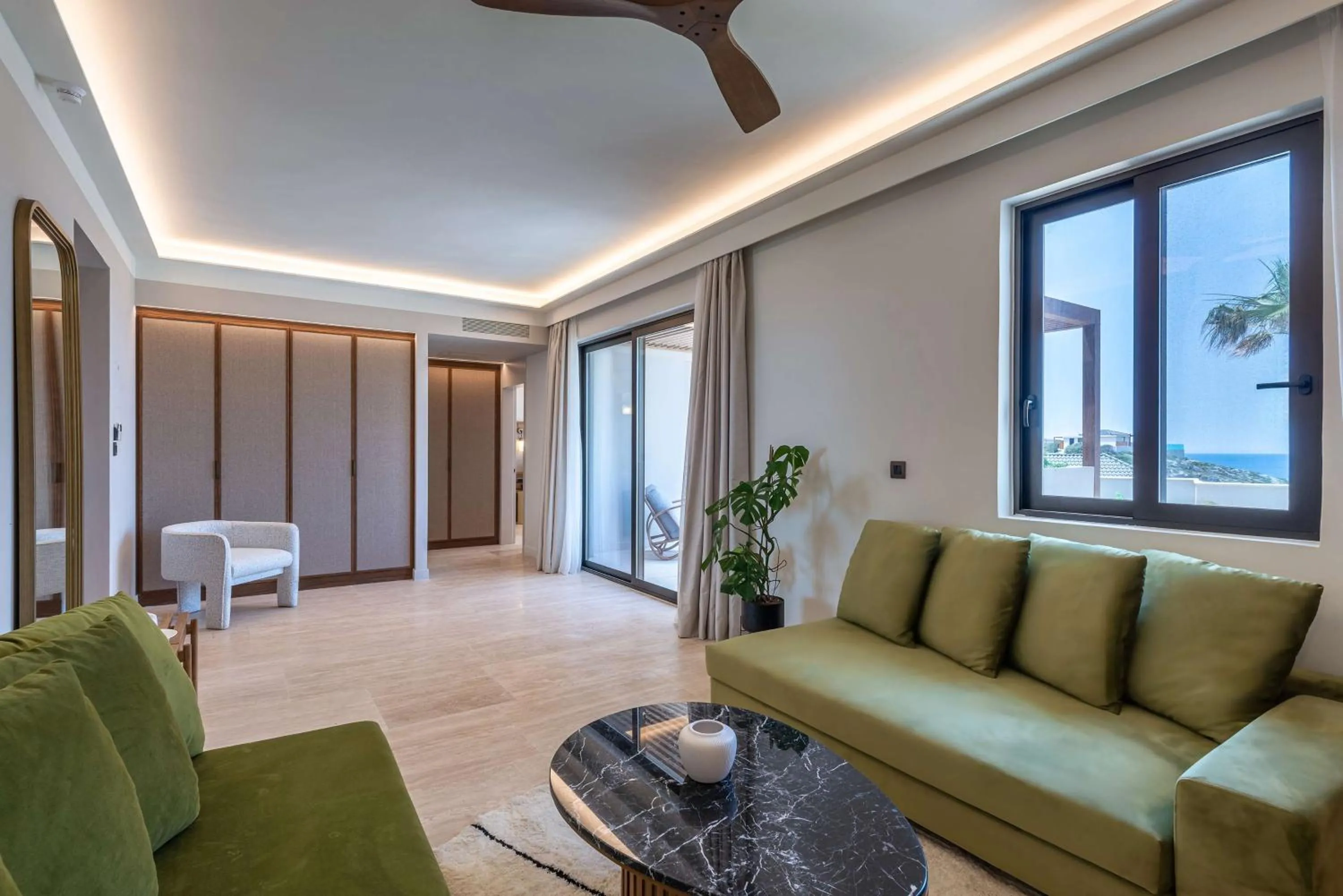 Living room in Isla Brown Chania Resort, Curio Collection by Hilton