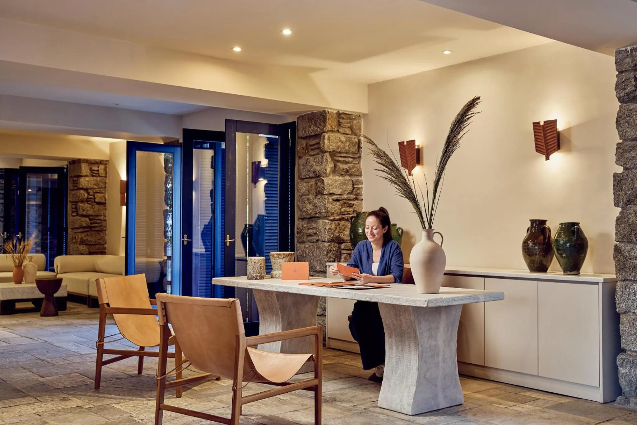 Communal lounge/ TV room in Mykonos Theoxenia, a Member of Design Hotels