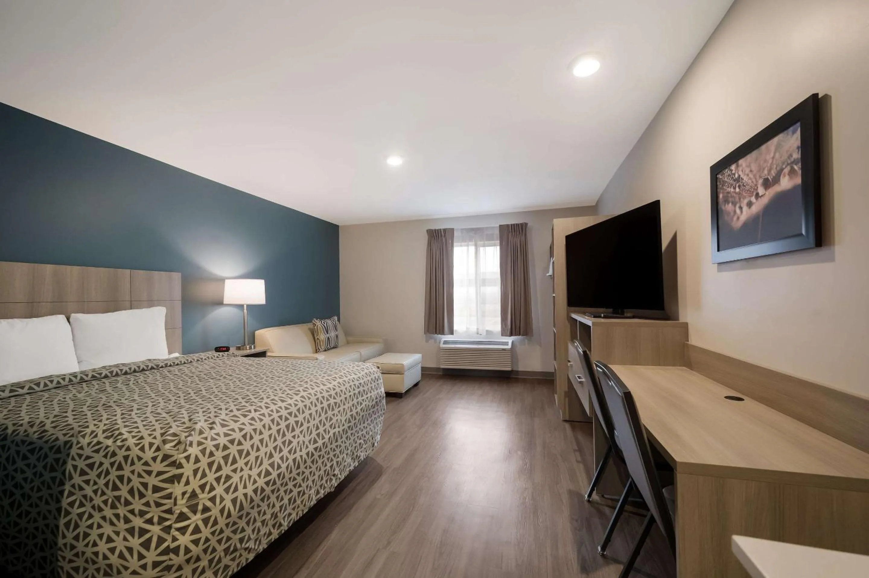 Bedroom, Bed in WoodSpring Suites Wixom - Novi