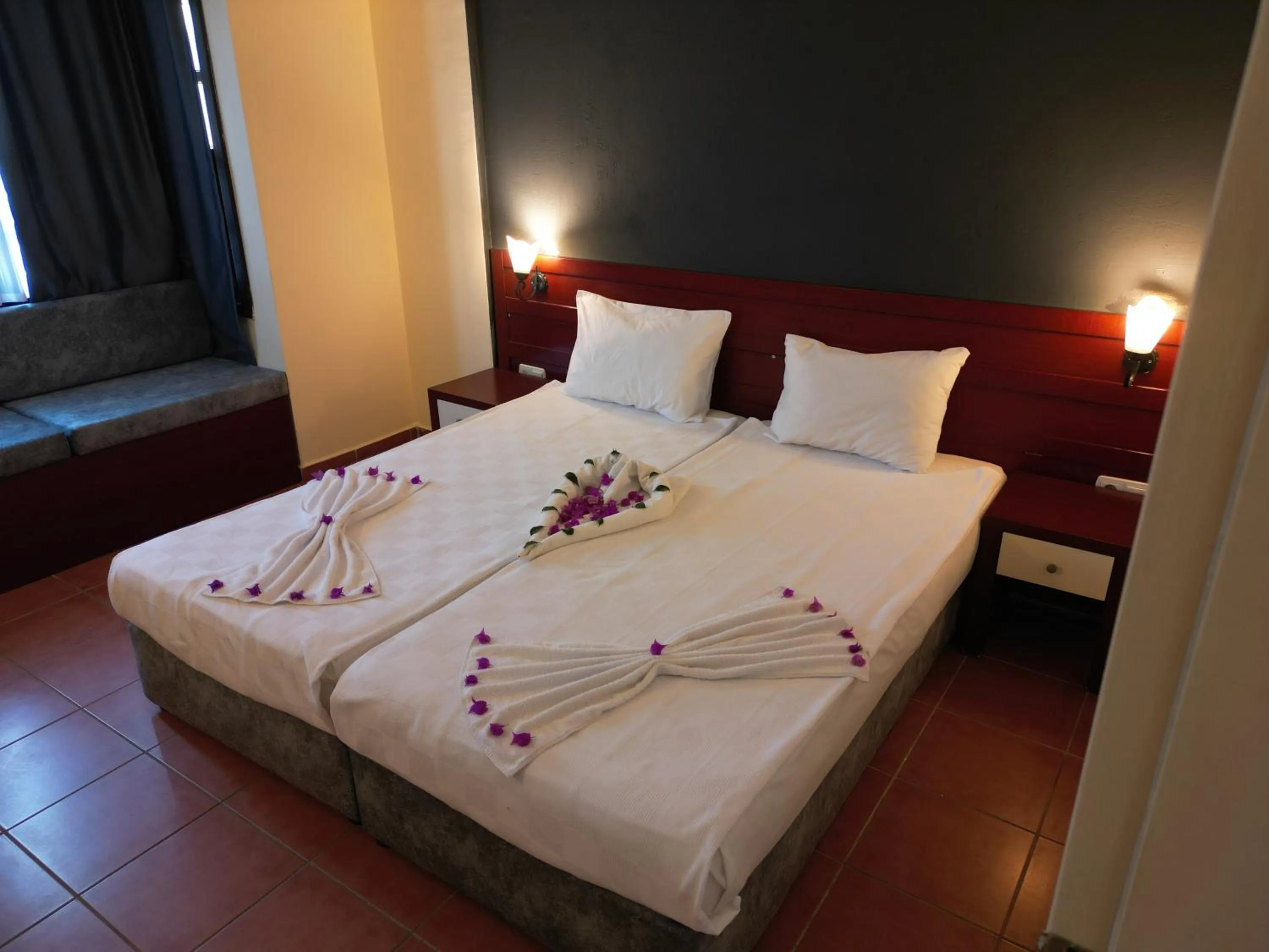 Bed in LEMAS SUITE HOTEL