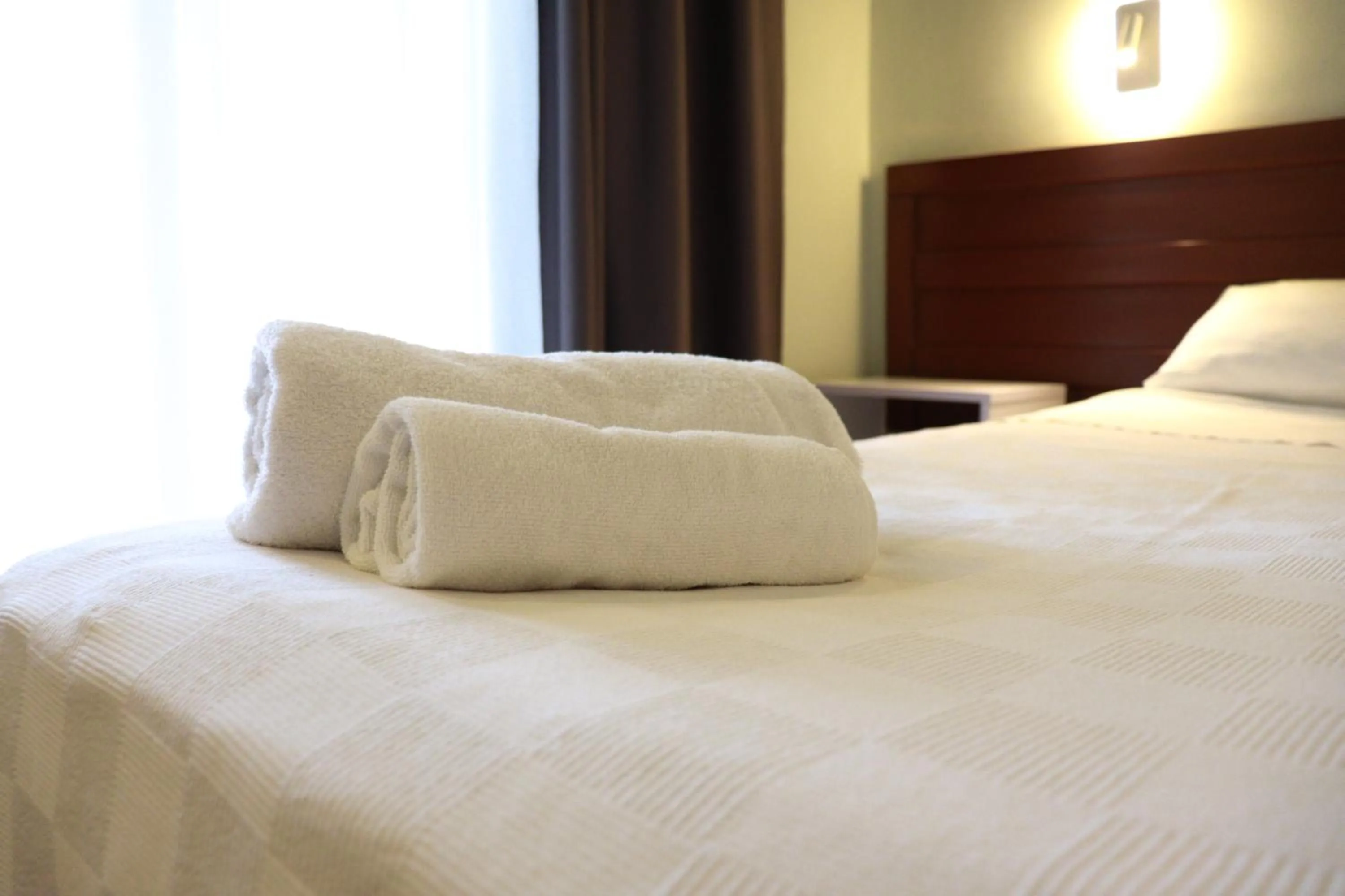 Bed in LEMAS SUITE HOTEL