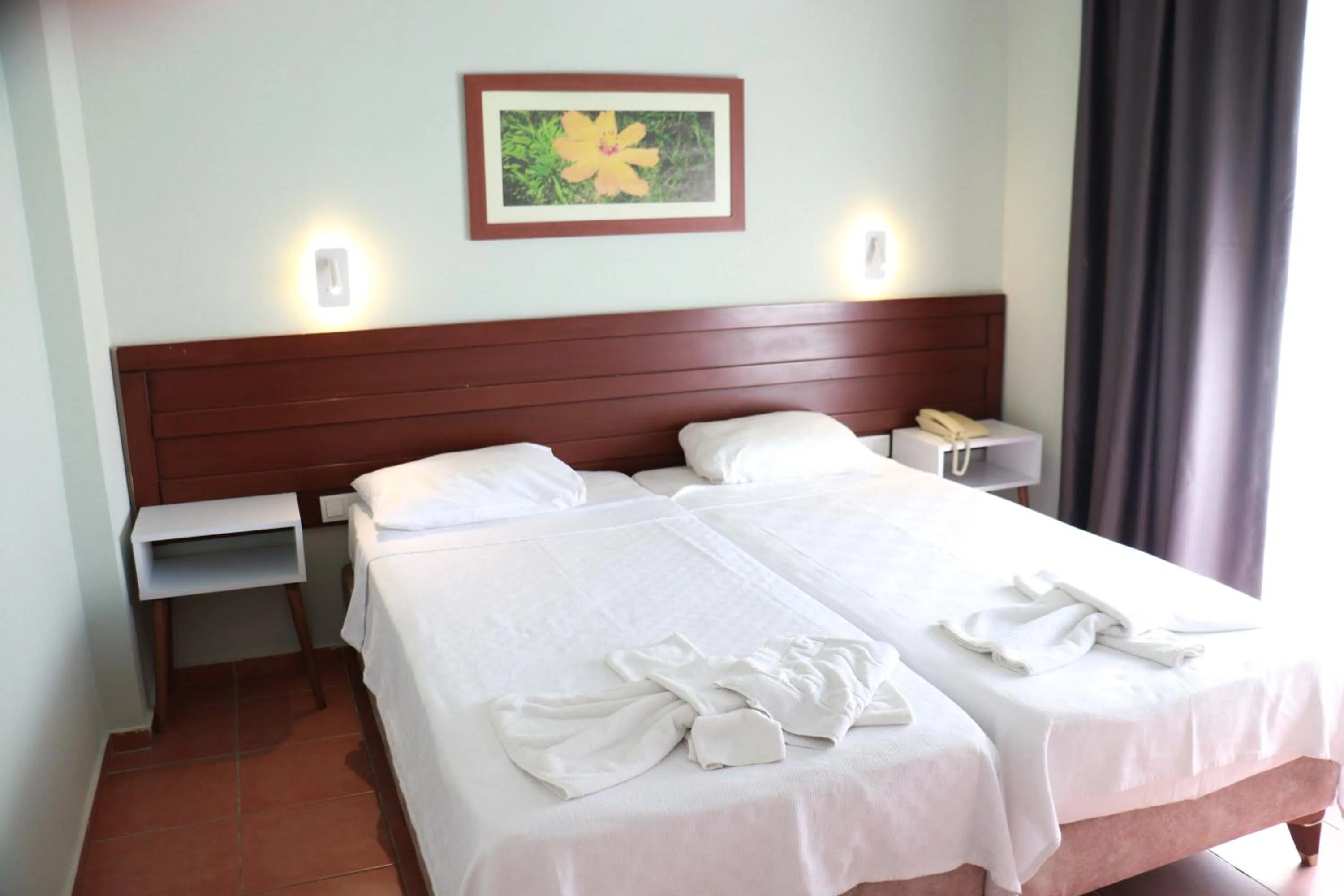 Bed in LEMAS SUITE HOTEL