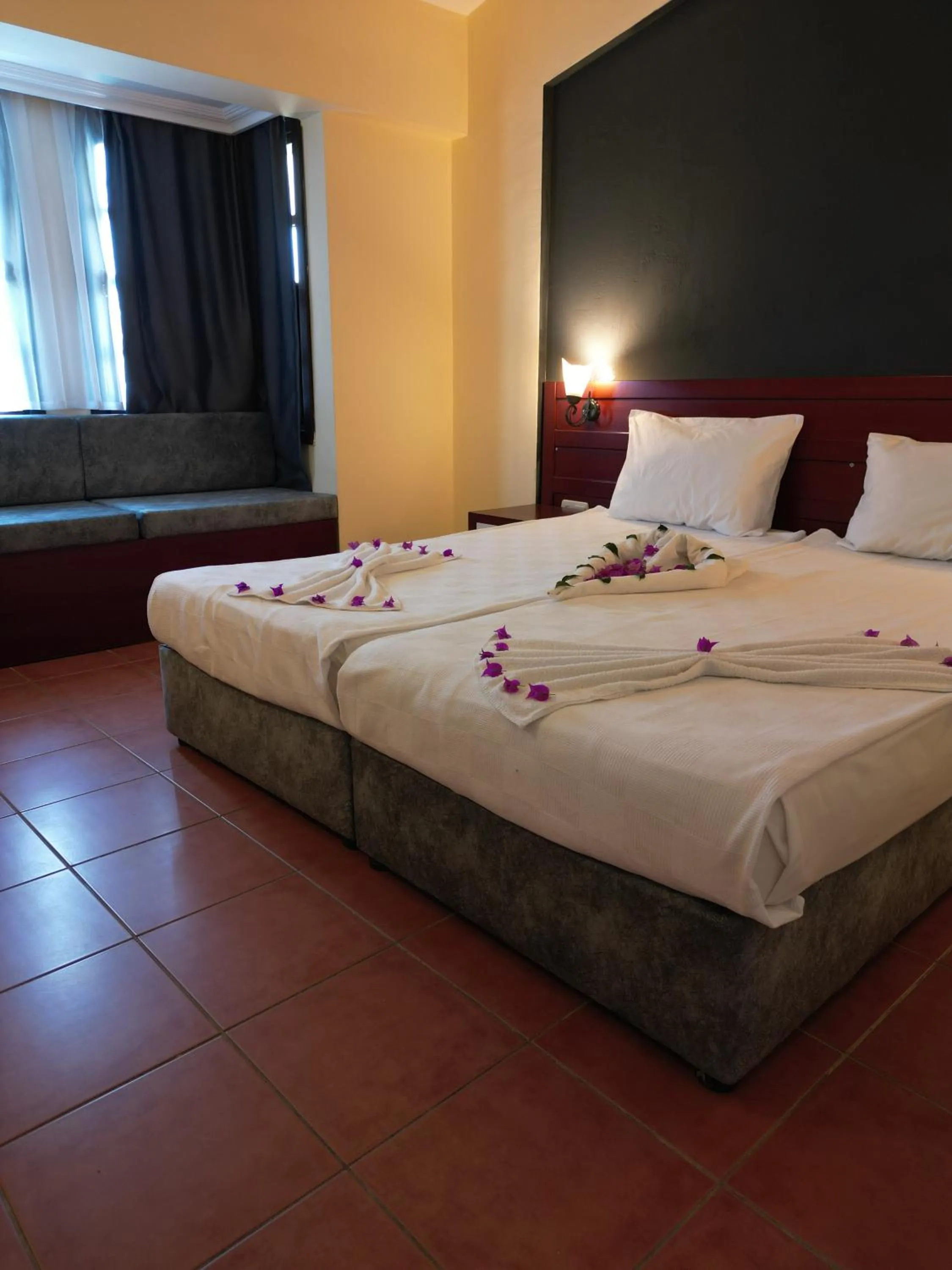 Bed in LEMAS SUITE HOTEL