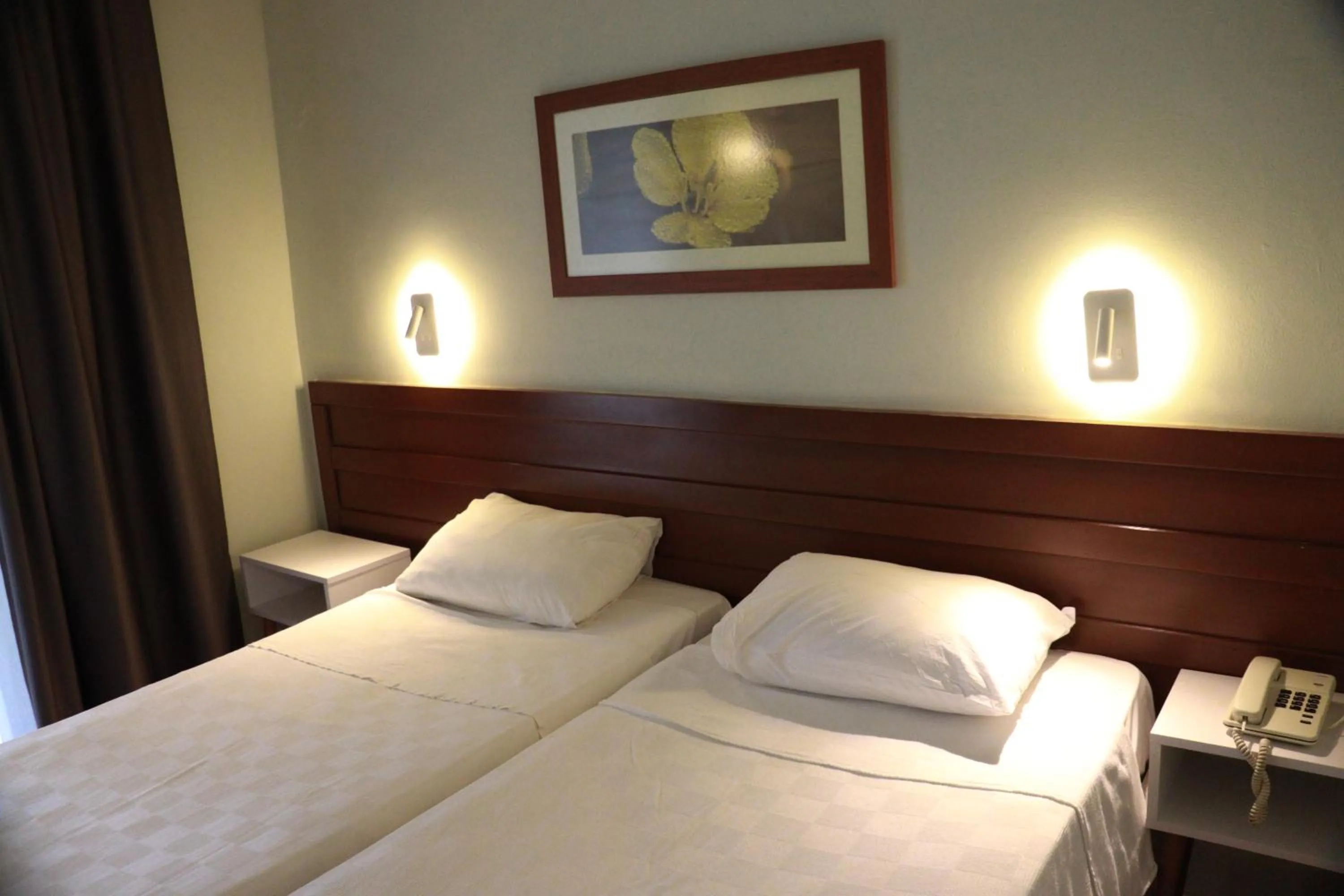 Bed in LEMAS SUITE HOTEL