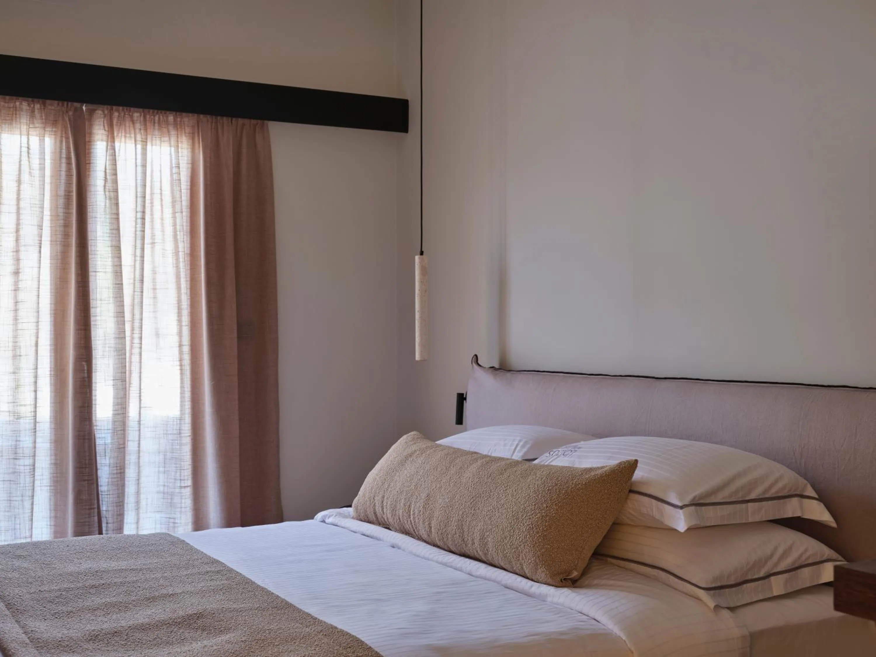 Bed in Loizos Stylish Residences