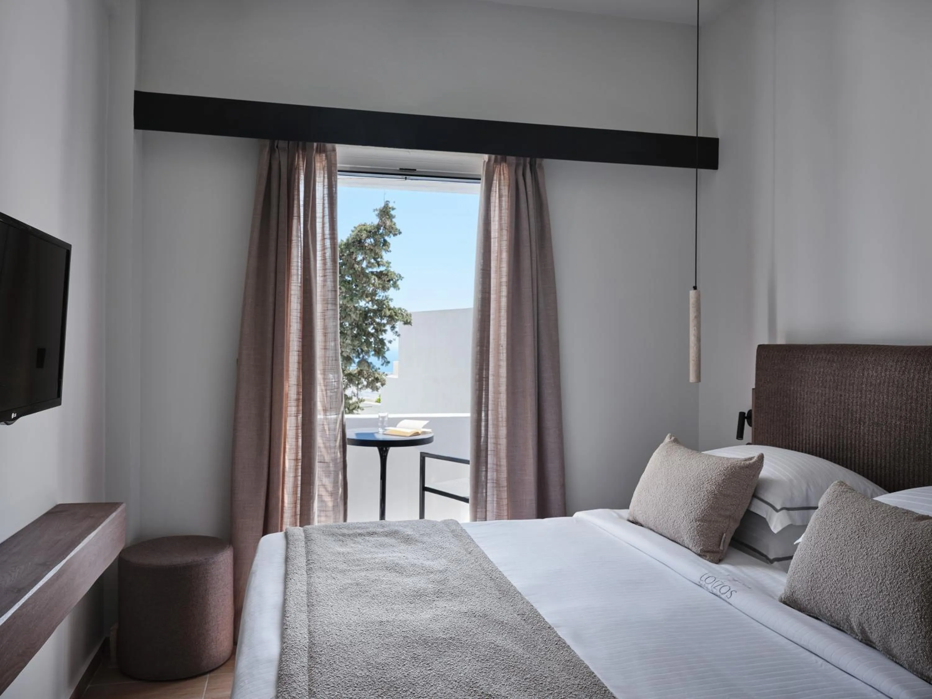 Bed in Loizos Stylish Residences