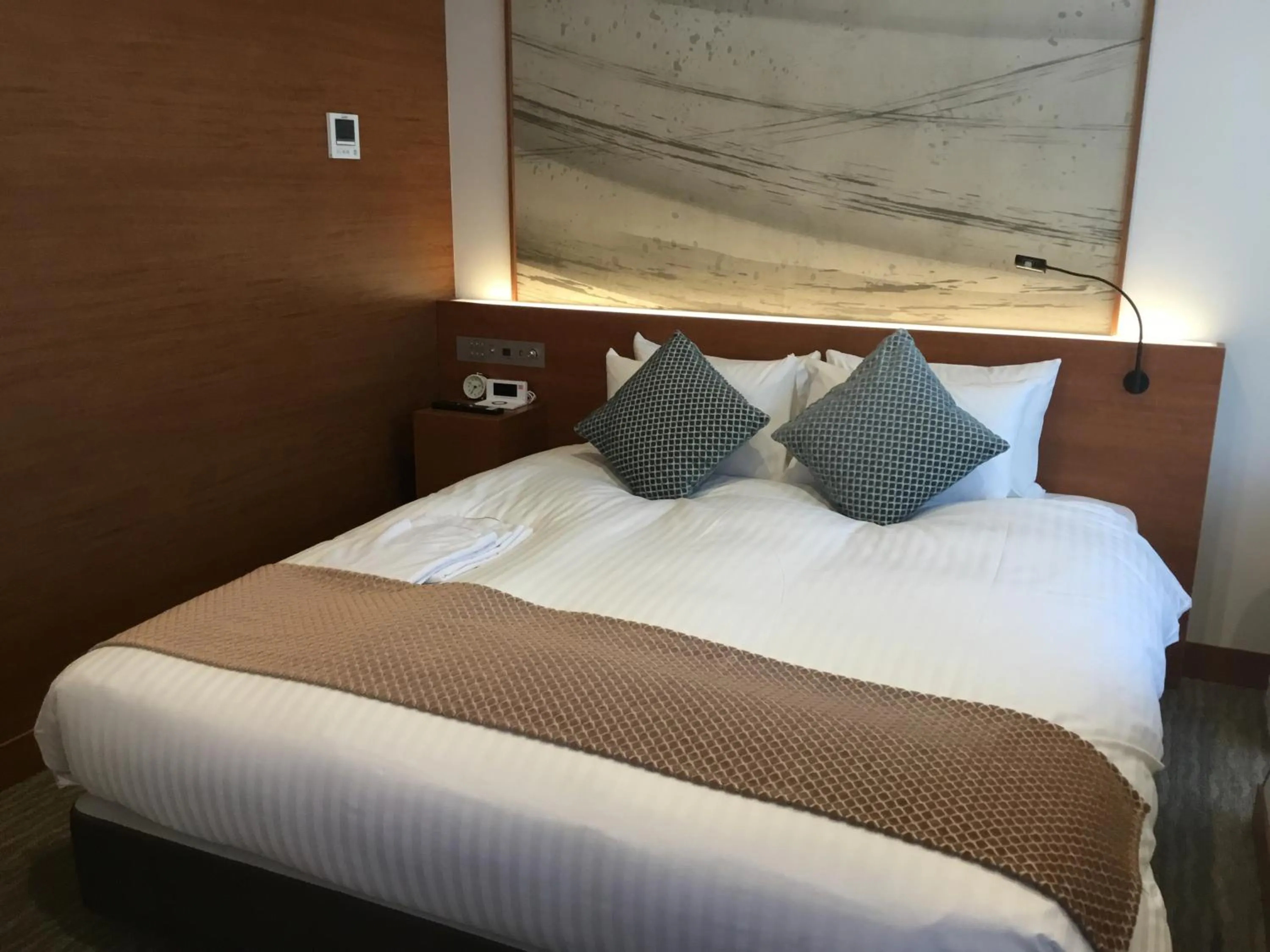 Bed in Odysis Suites Osaka Airport Hotel