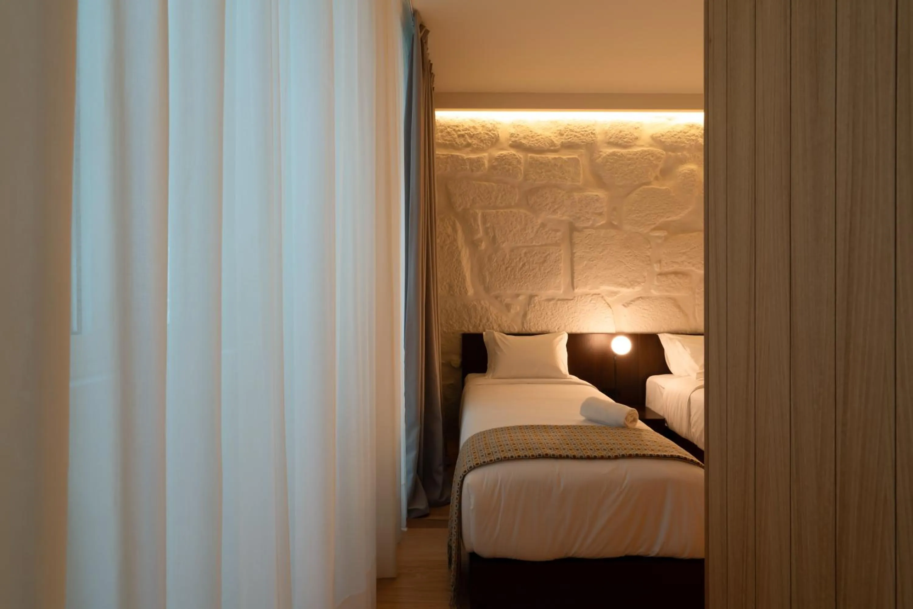 Bed in d'ALMA Boutique Hotel