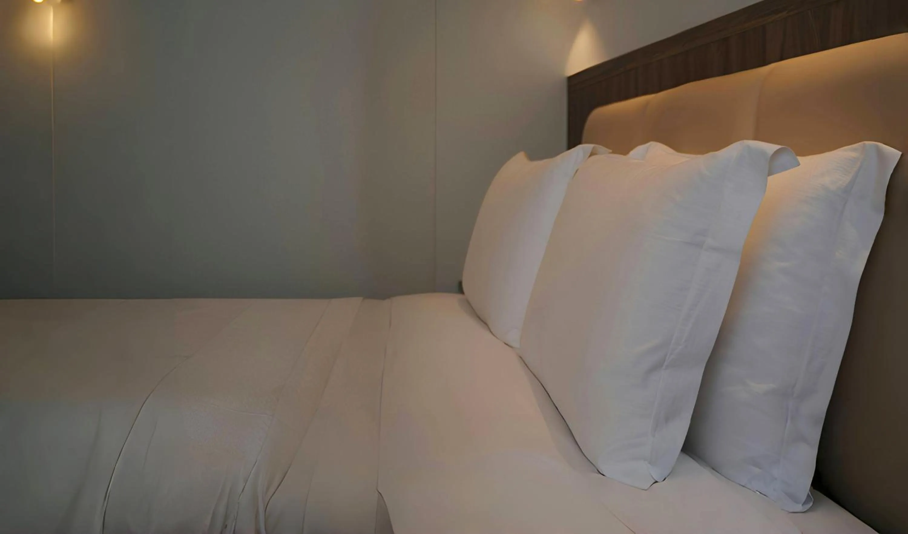 Bed in Escale International Hotel