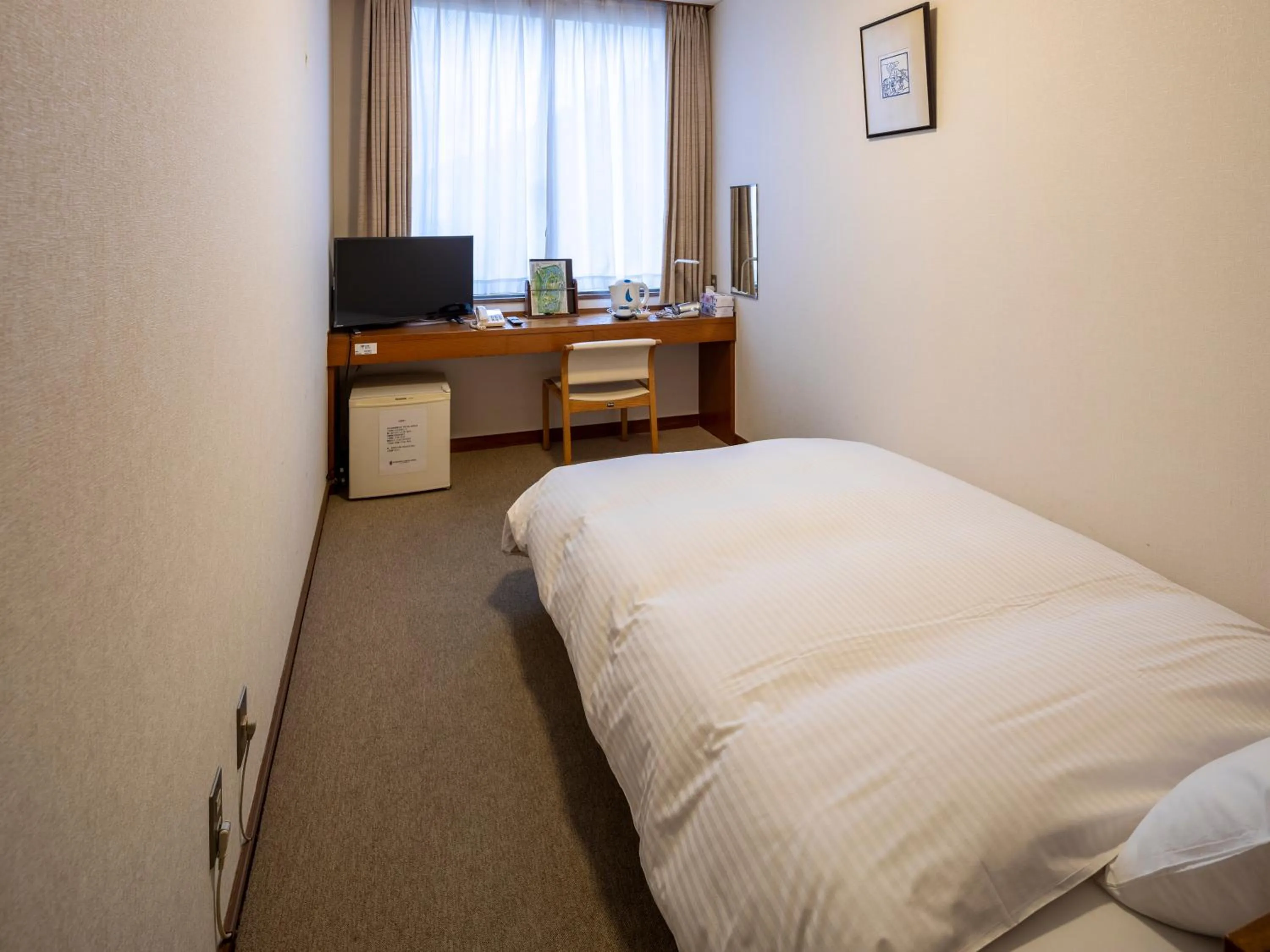 Bed in KANEMITSU CAPITAL HOTEL