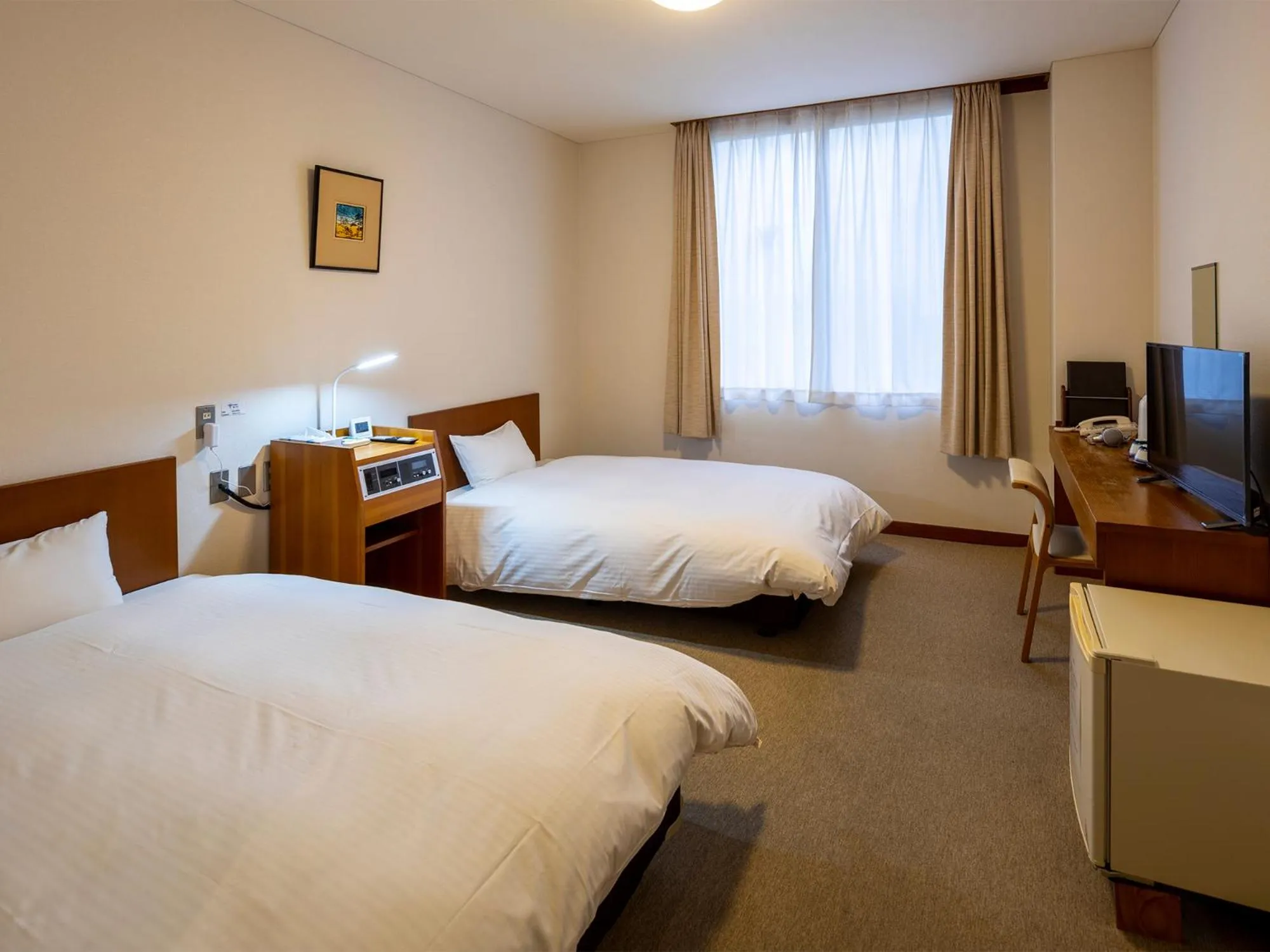 Bed in KANEMITSU CAPITAL HOTEL