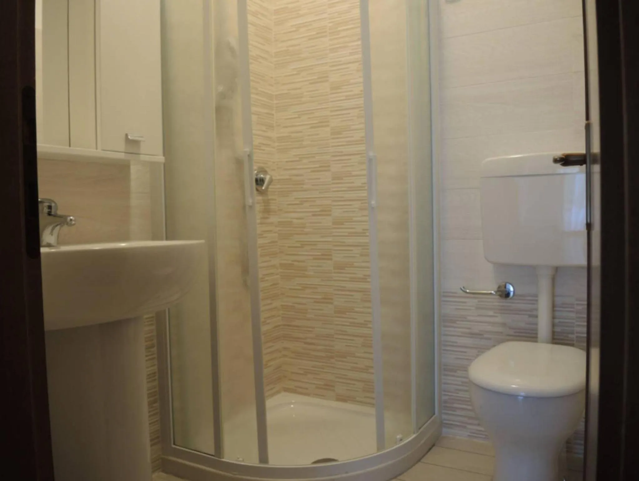 Toilet in Family apartment steps from Pluto Beach