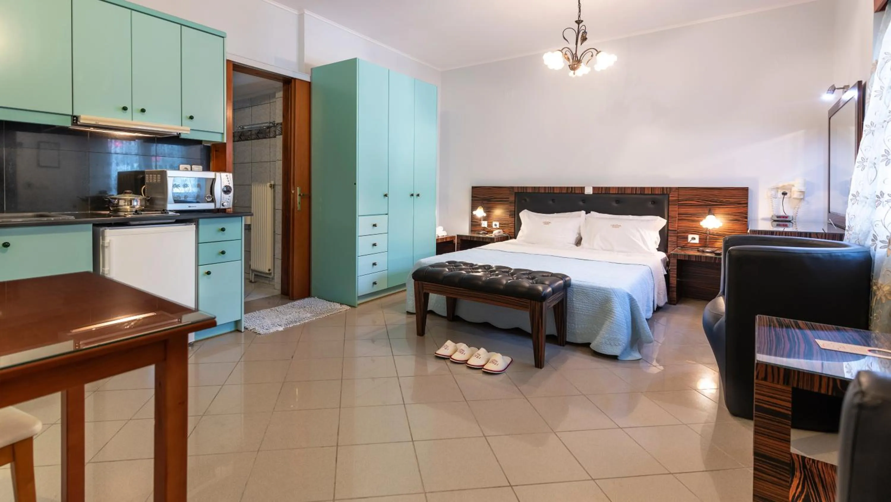 Kitchen or kitchenette, Bed in Irida Beach Resort Suites