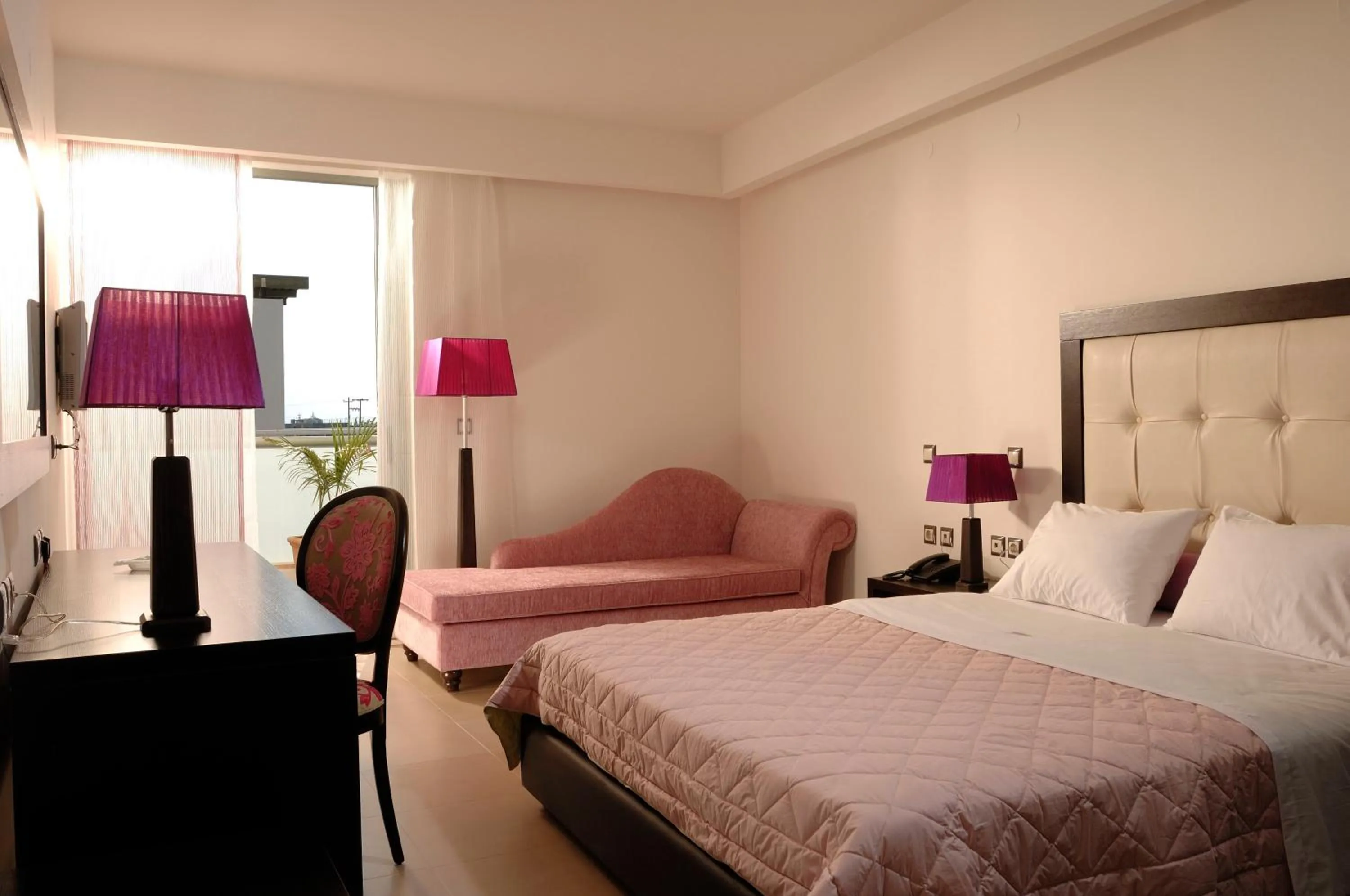 Bed in Angela Suites Boutique Hotel