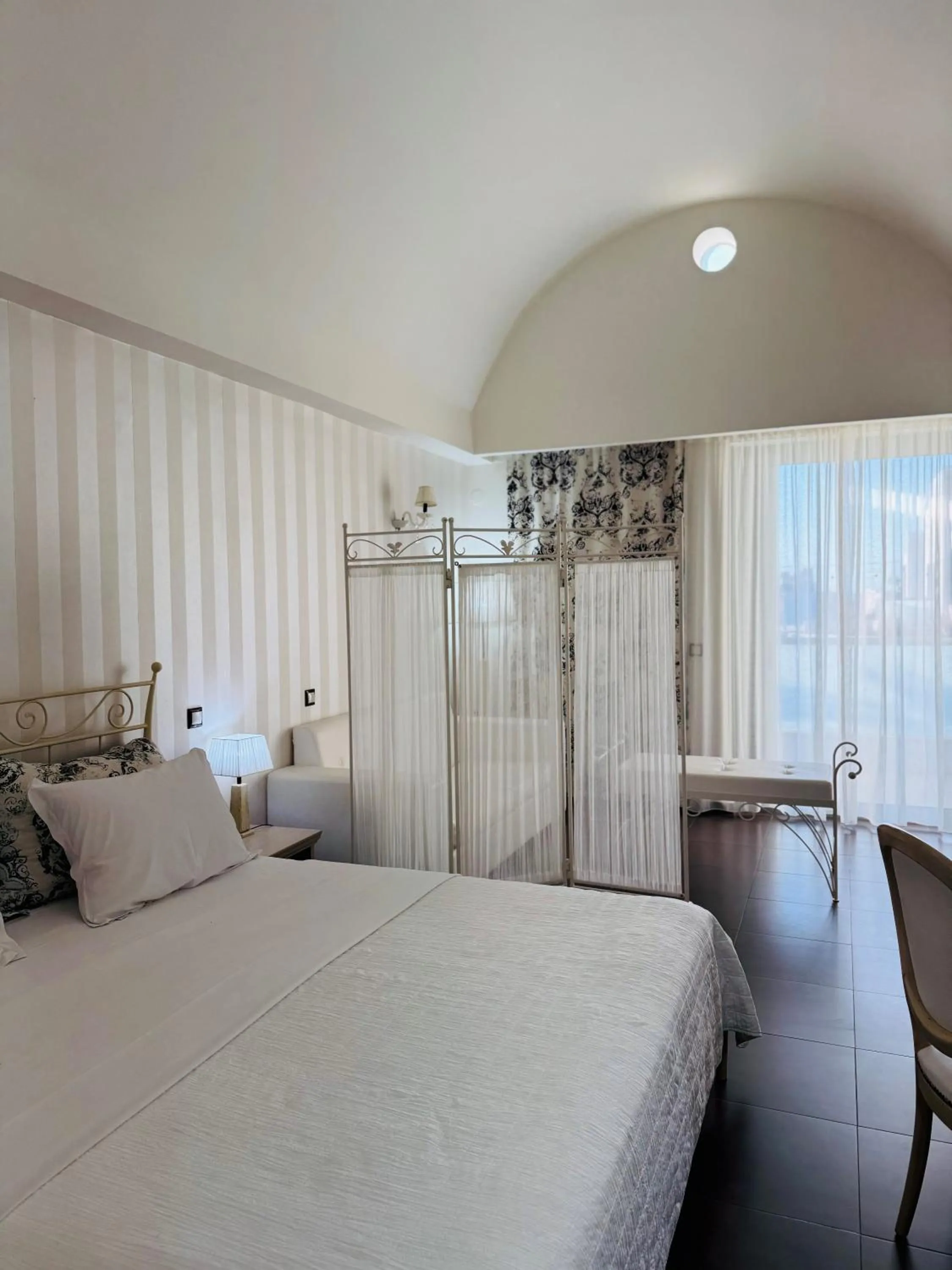 Bed in Angela Suites Boutique Hotel