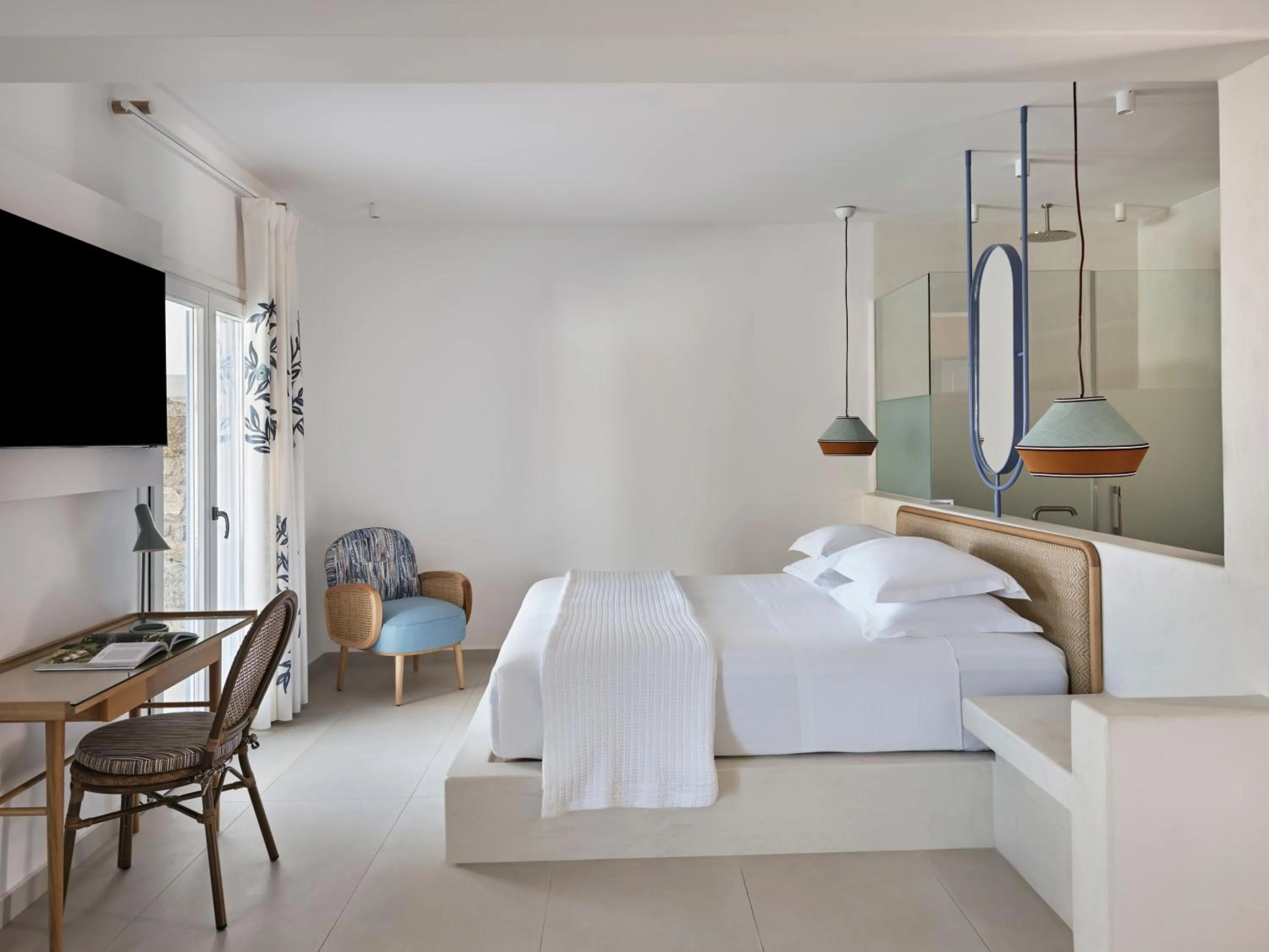 Bed in Myconian Sunrise Relais & Chateaux Hotel