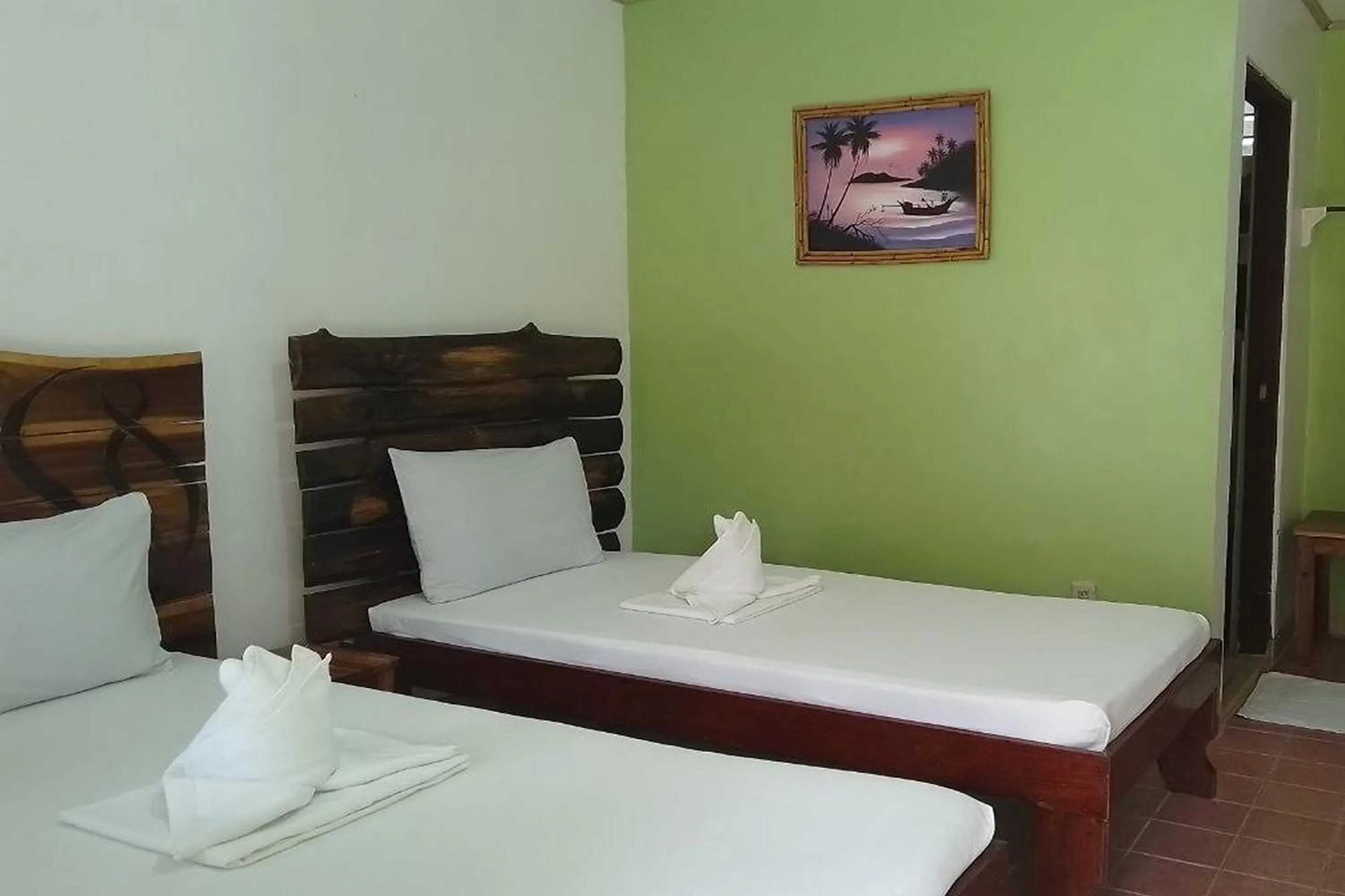 Bed in Summer Homes Beach Front Resort and Cottages Port Barton