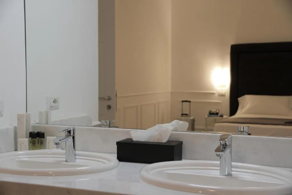 Bed in RAVIDA SUITES