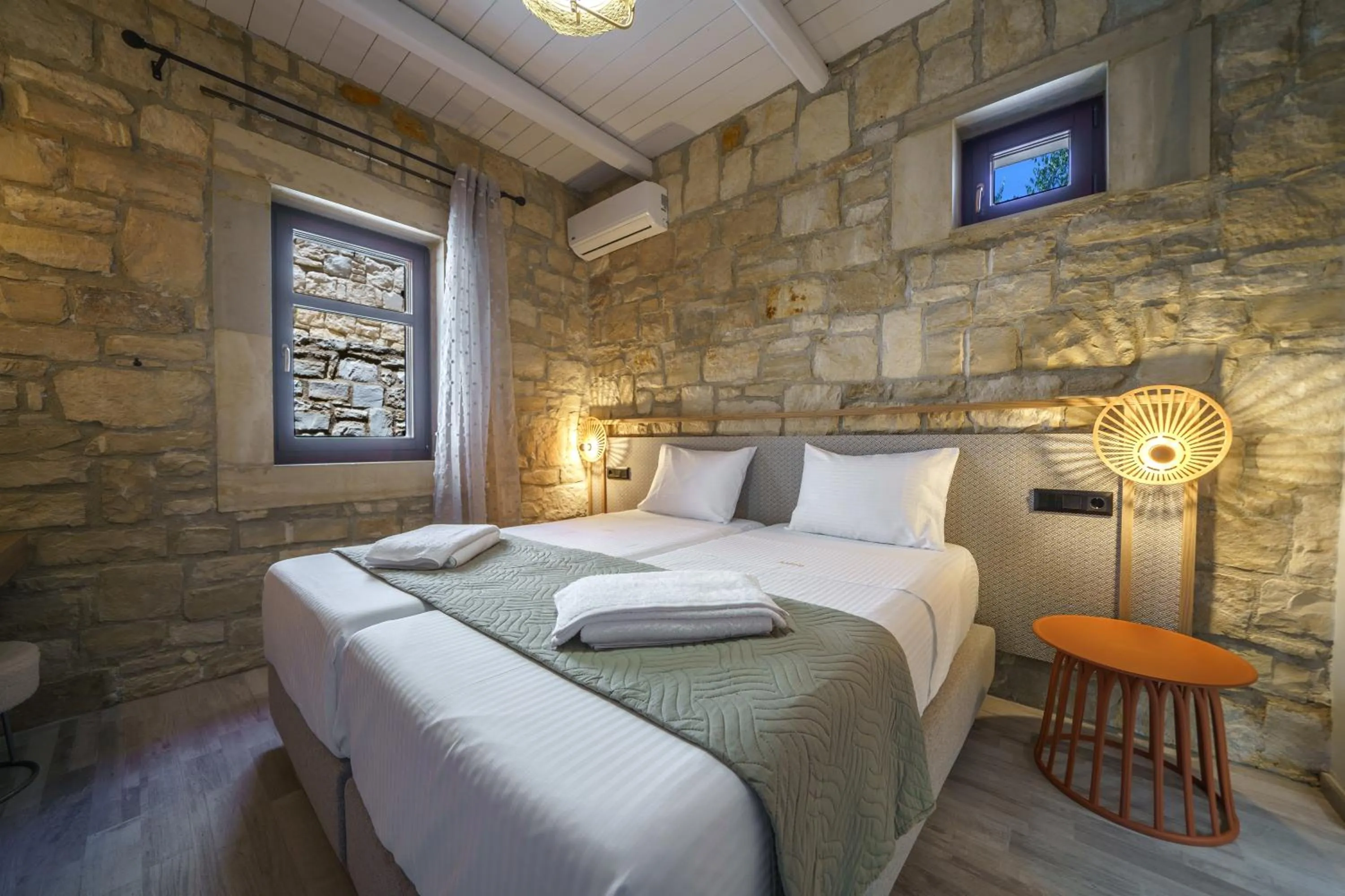 Bed in Asion Lithos Suites with Private Pools