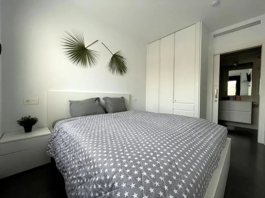 Bed in Modern Apartment with pool area