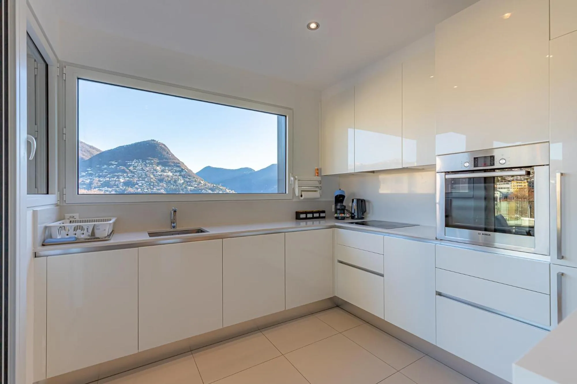 Kitchen or kitchenette in IMPERIAL of LUGANO 3 with a lake view behind the station and 10 min from the lake of Lugano