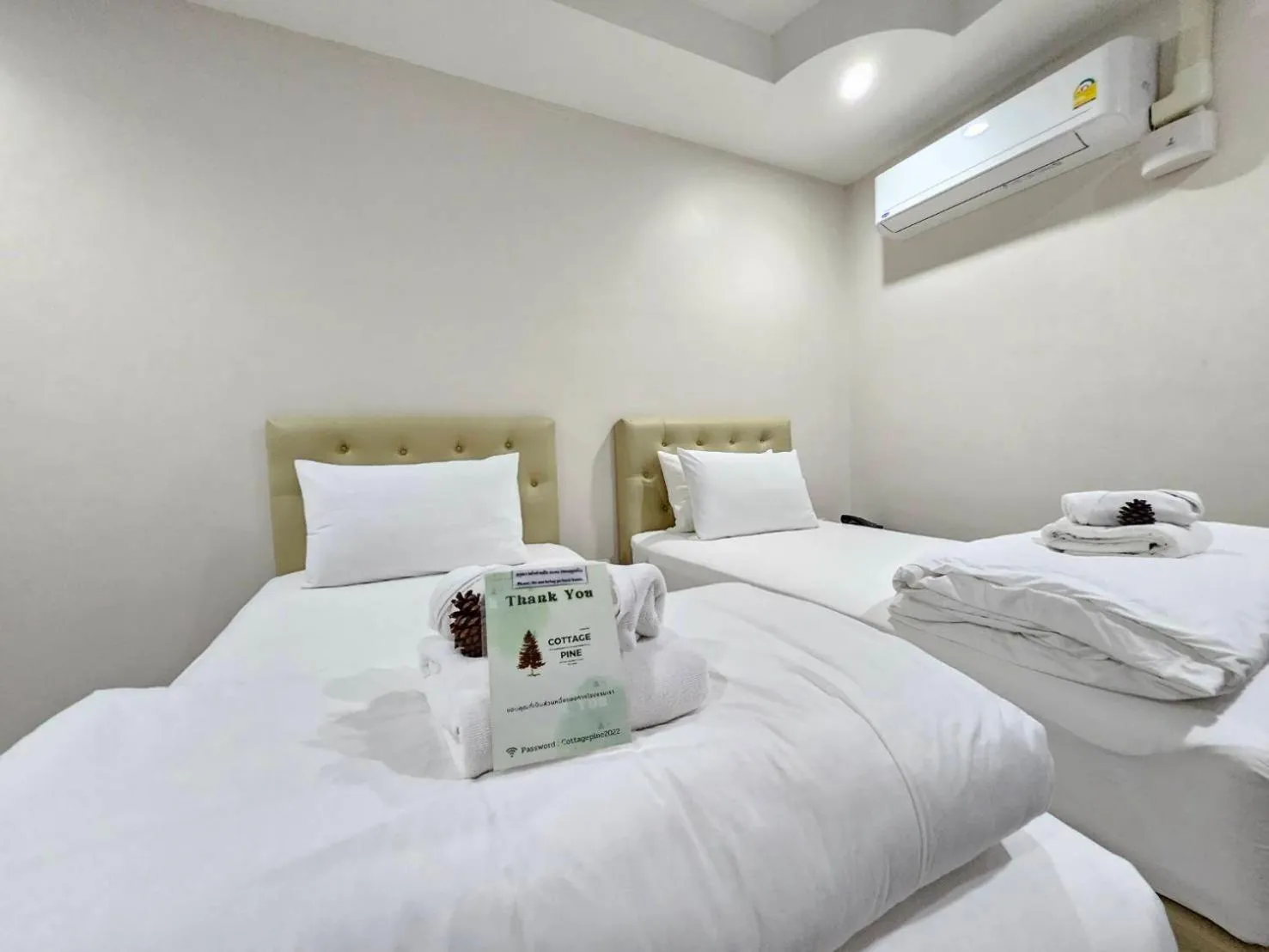 Bed in CottagePine Rayong Resort&Cafe