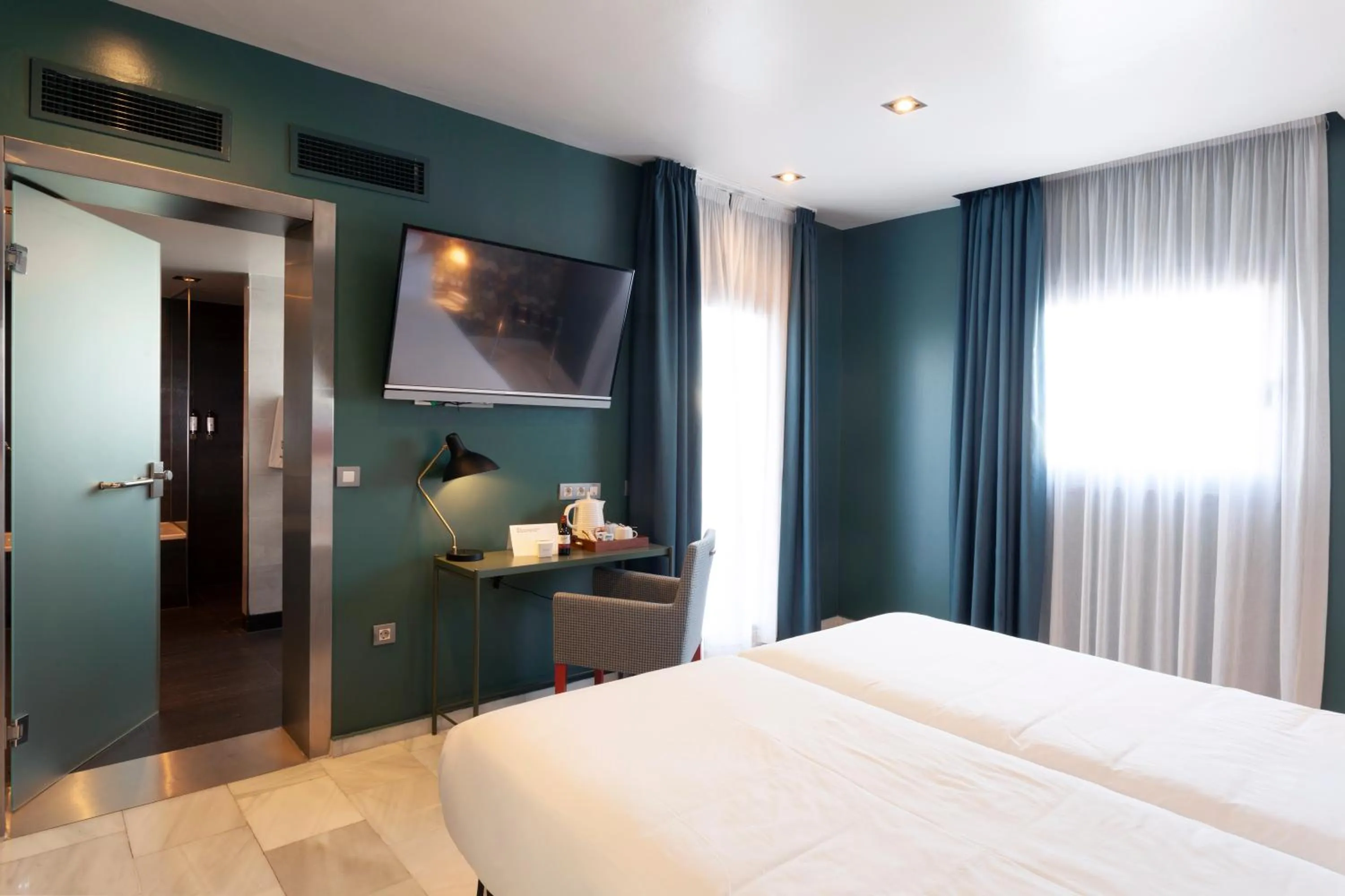 Bed in Petit Palace Puerta de Triana