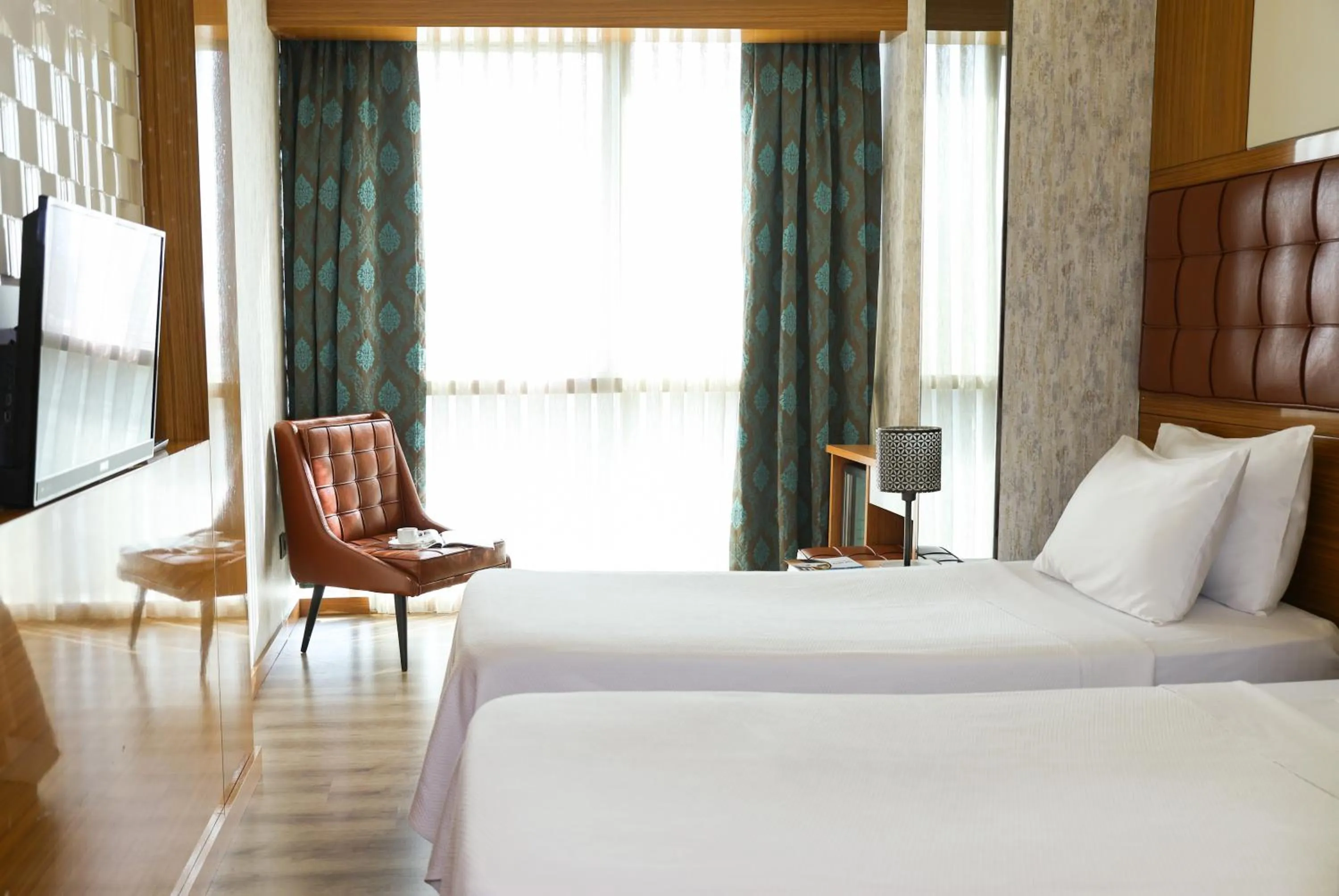 Bed in The Hera Platinum Hotel