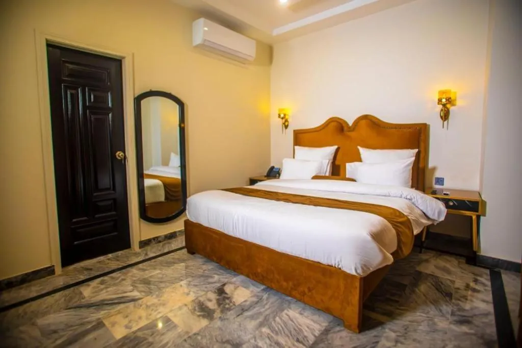 Bed in The Rich Hotel & Apartments