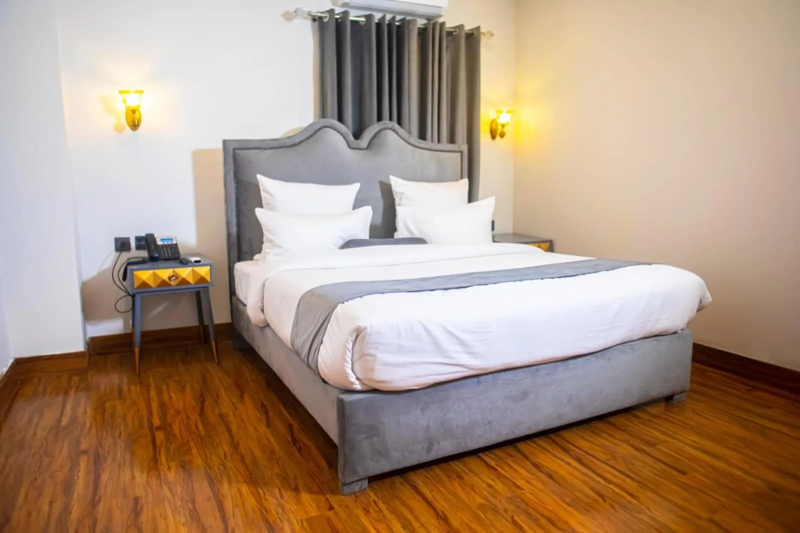 Bed in The Rich Hotel & Apartments