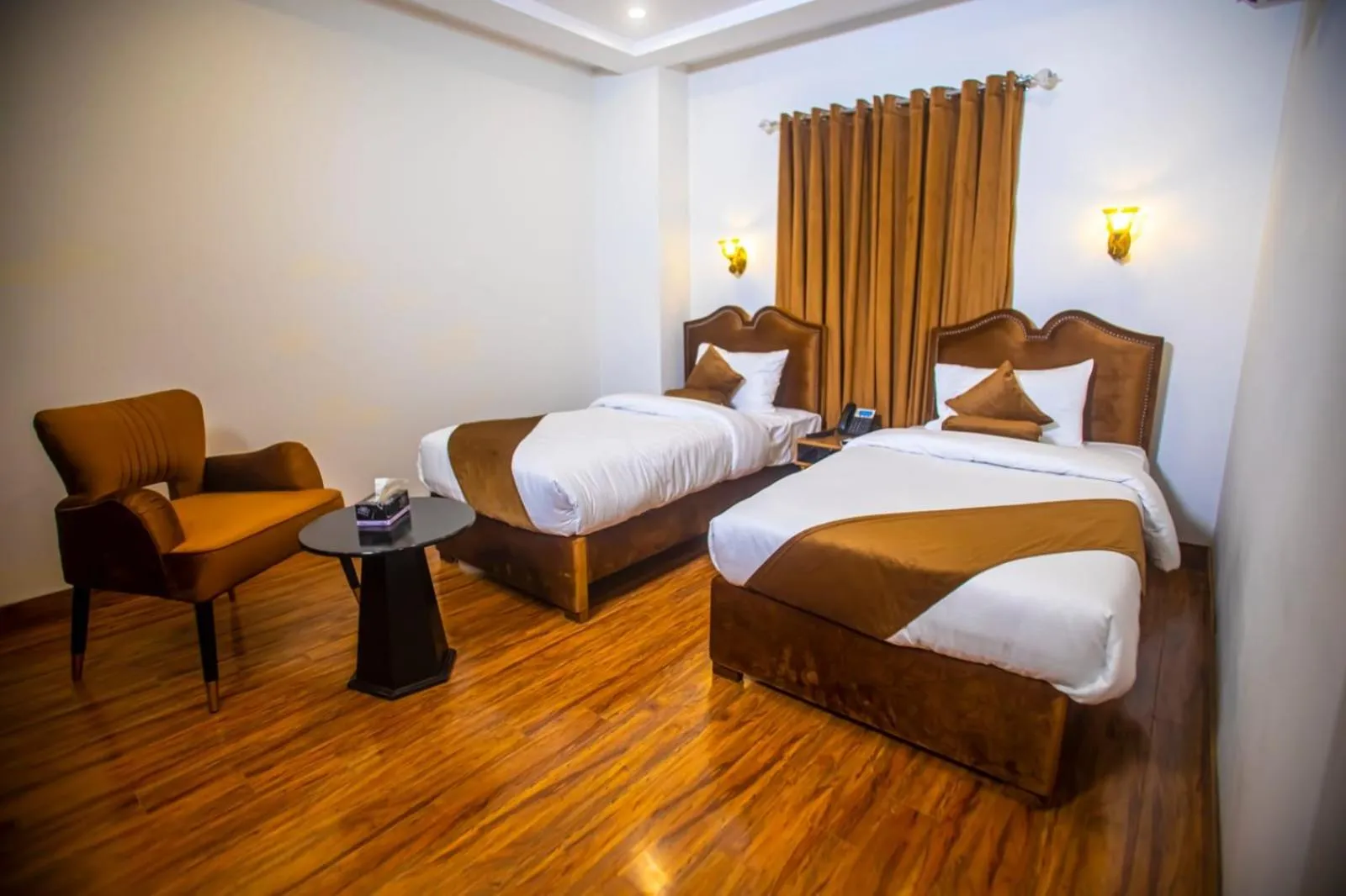 Bed in The Rich Hotel & Apartments