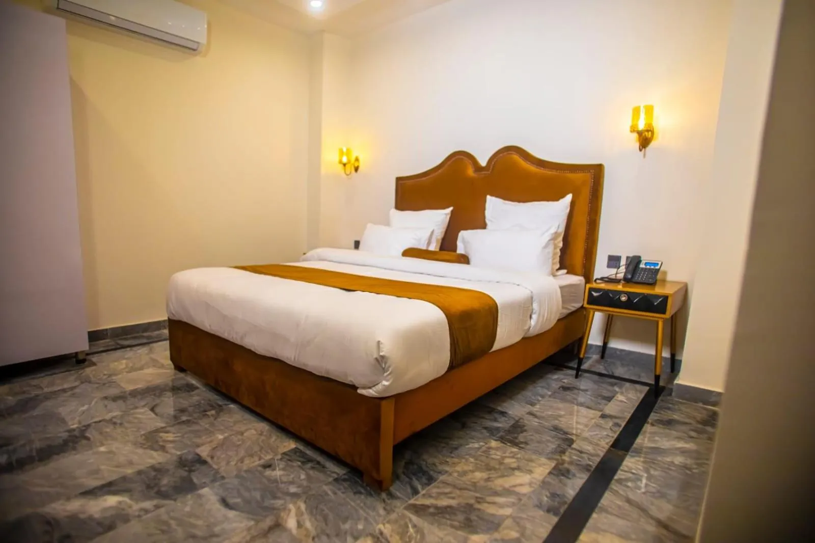 Bed in The Rich Hotel & Apartments