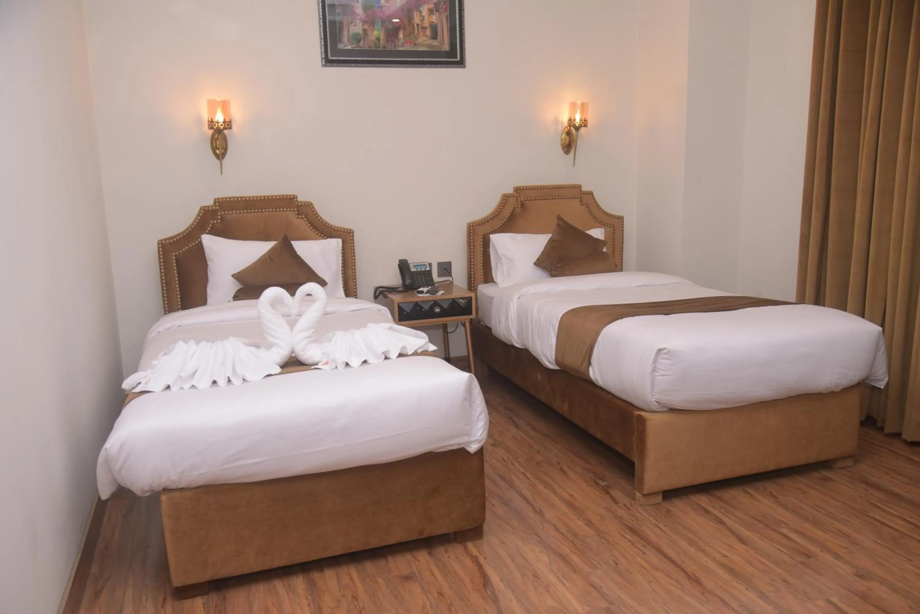 Bed in The Rich Hotel & Apartments