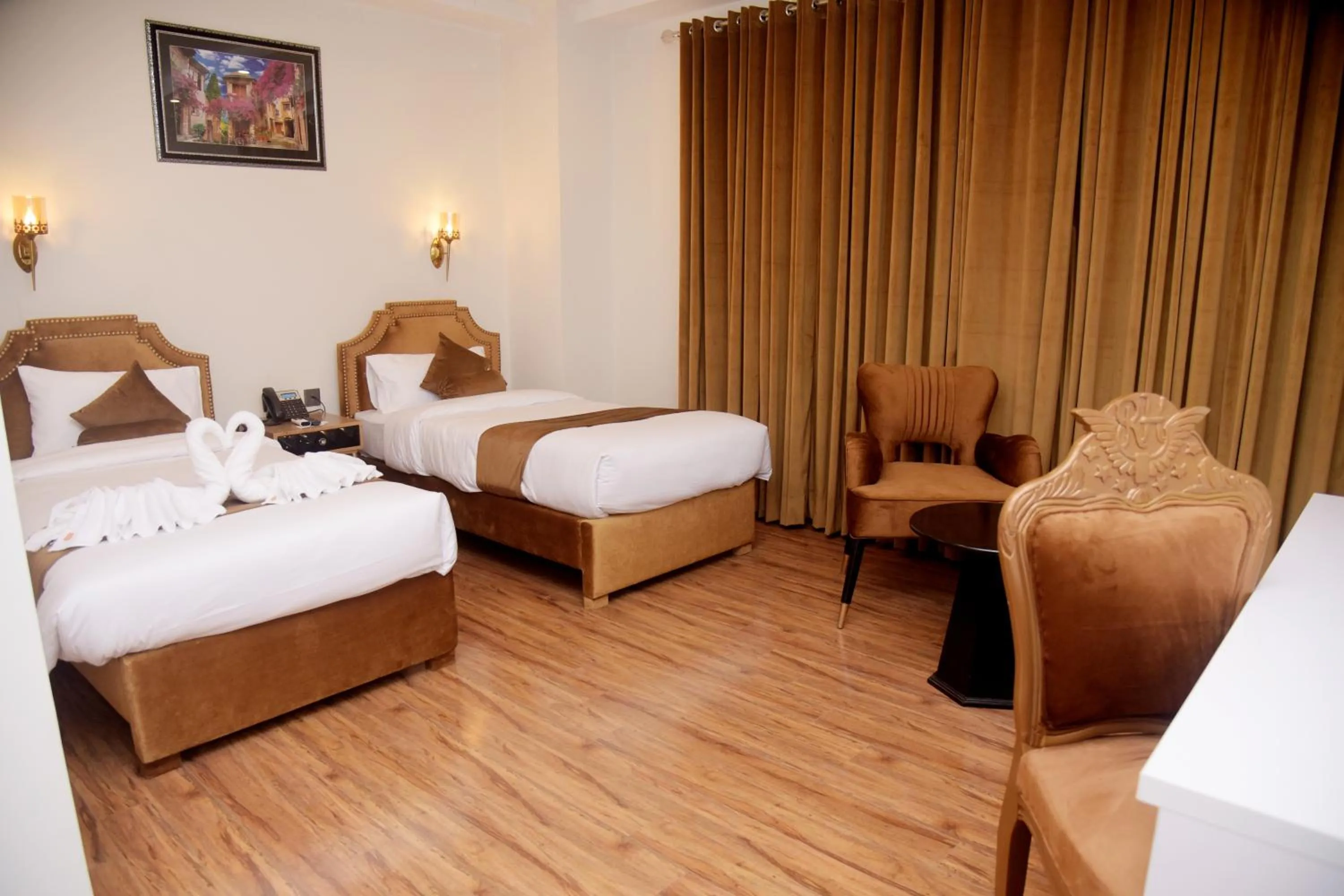 Bed in The Rich Hotel & Apartments