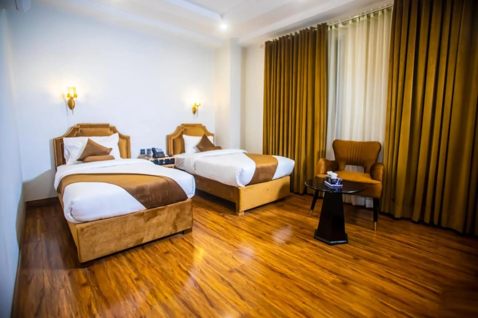 Bed in The Rich Hotel & Apartments