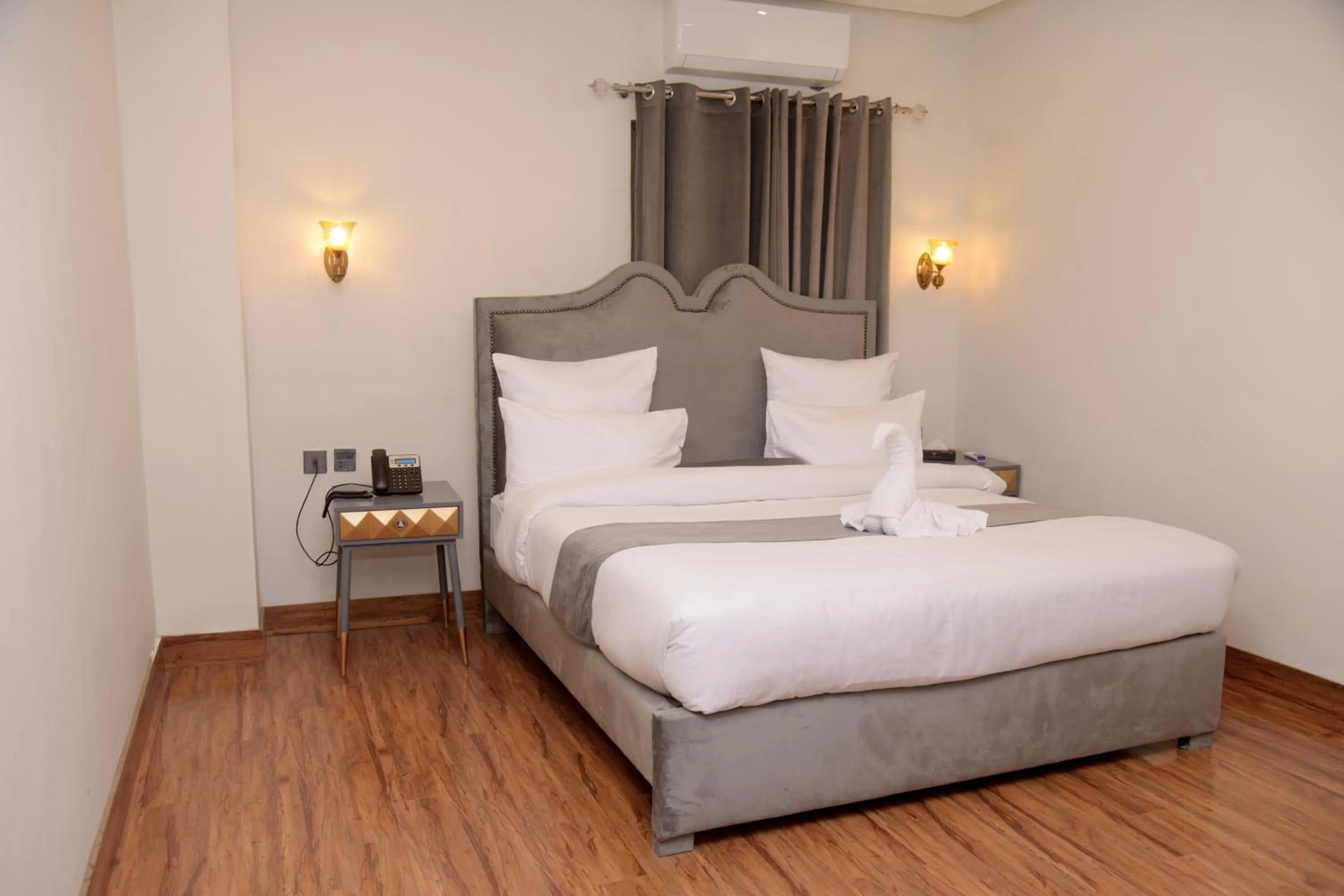 Bed in The Rich Hotel & Apartments