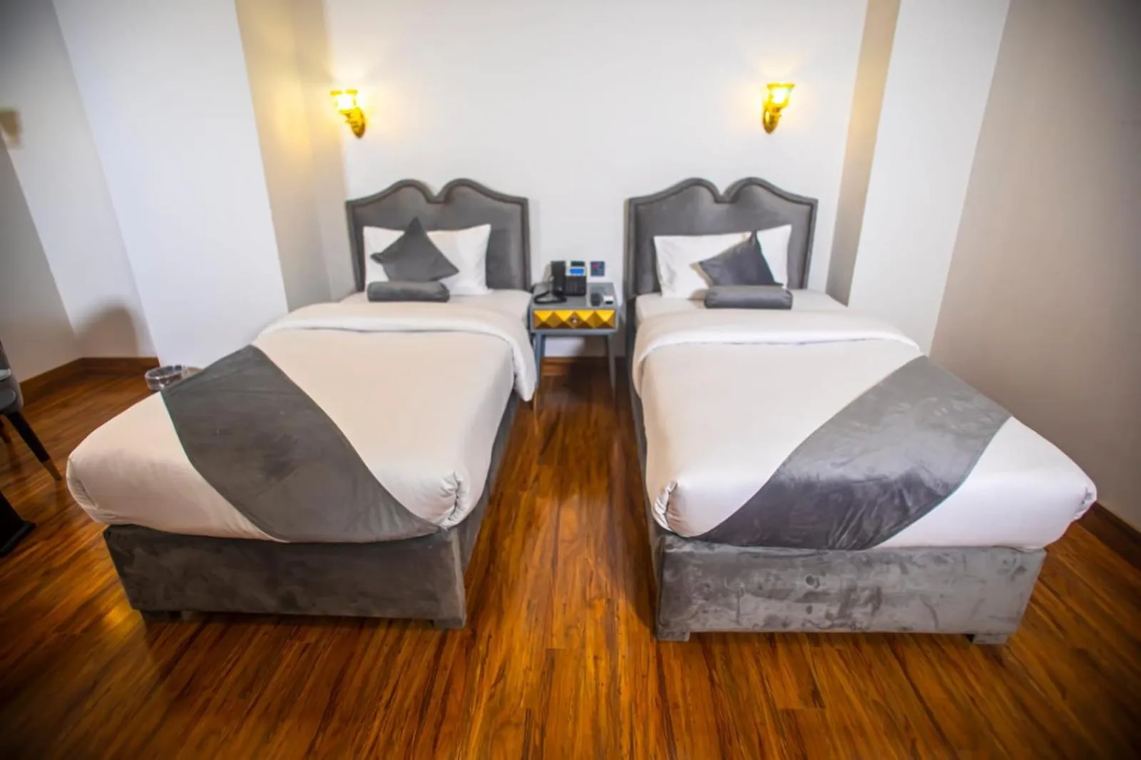 Bed in The Rich Hotel & Apartments