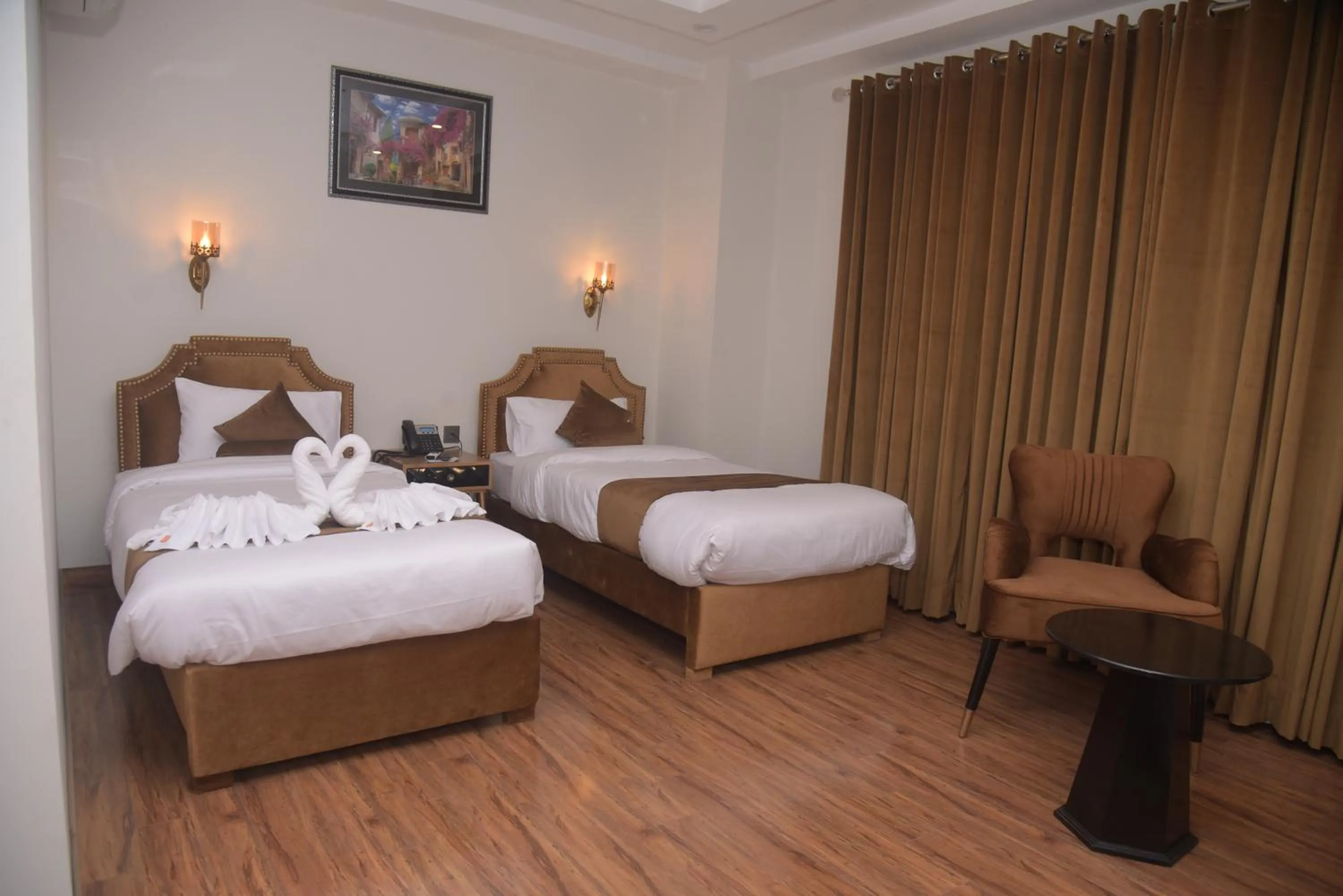 Bed in The Rich Hotel & Apartments