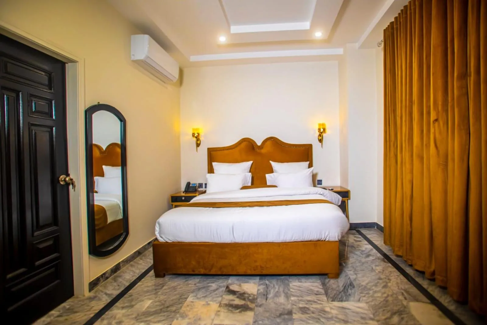 Bed in The Rich Hotel & Apartments