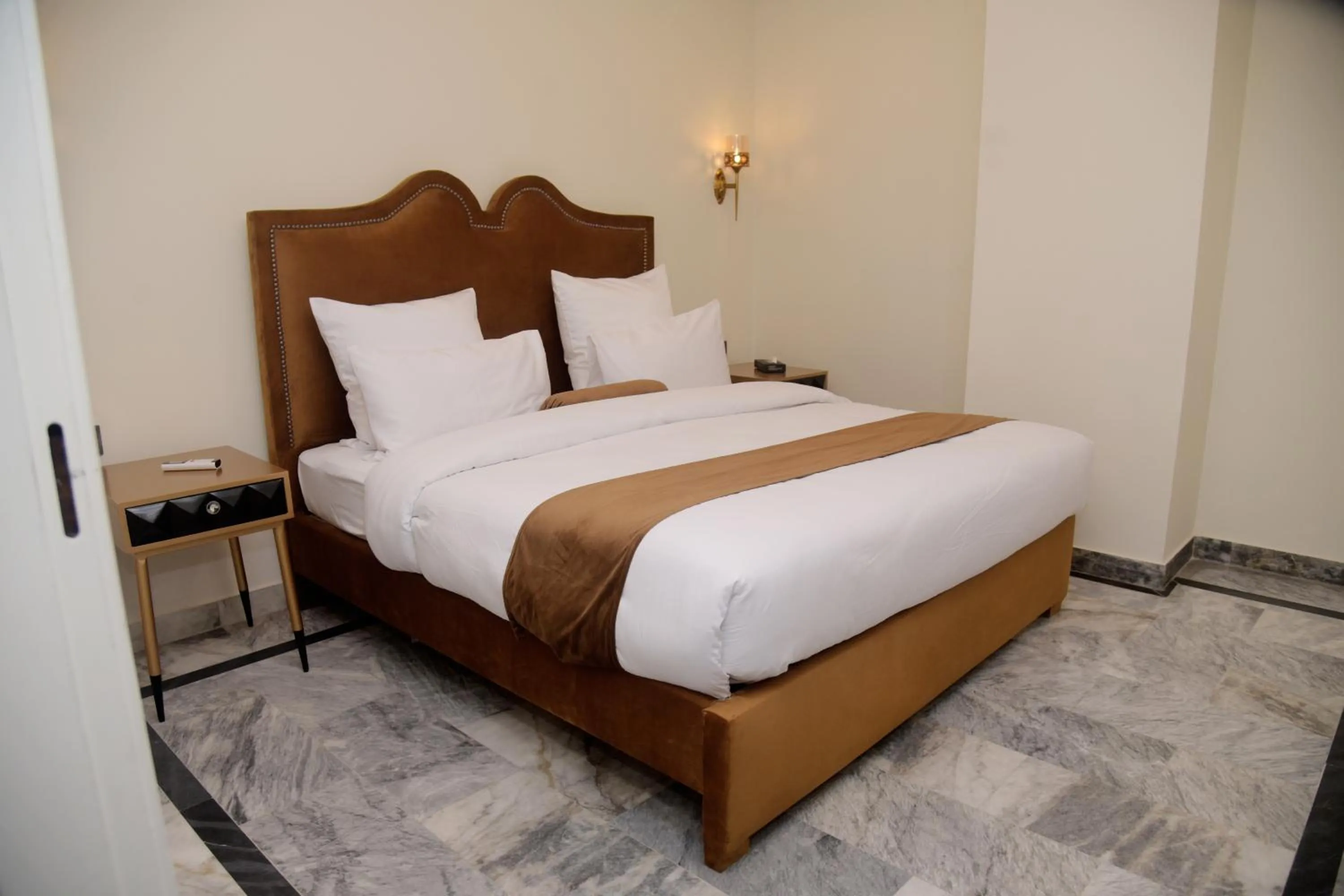 Bed in The Rich Hotel & Apartments