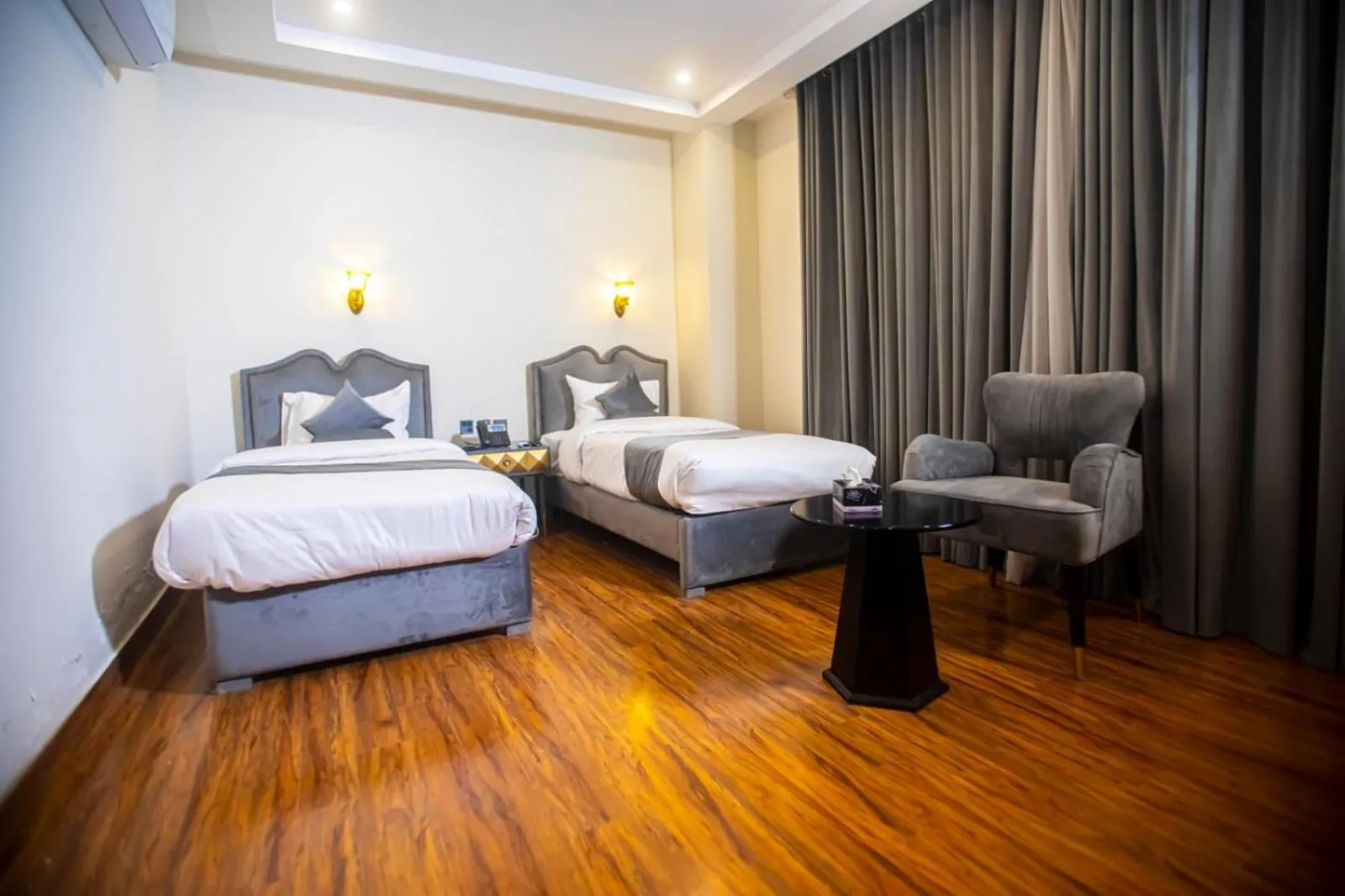 Bed in The Rich Hotel & Apartments