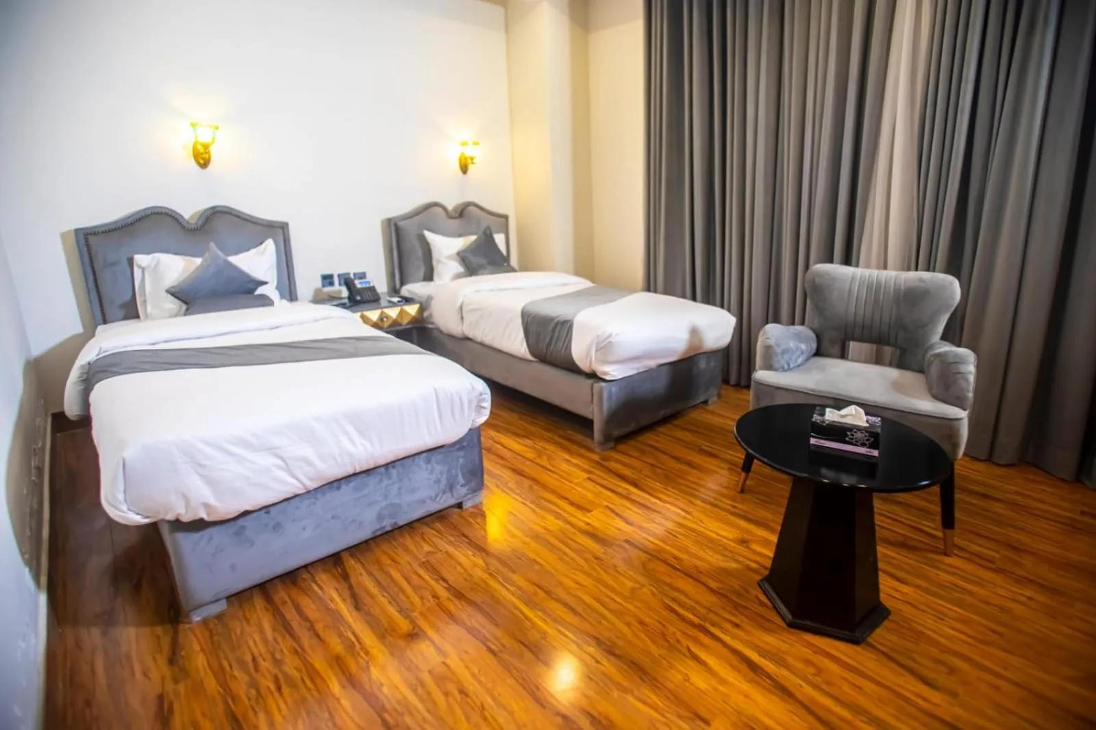 Bed in The Rich Hotel & Apartments