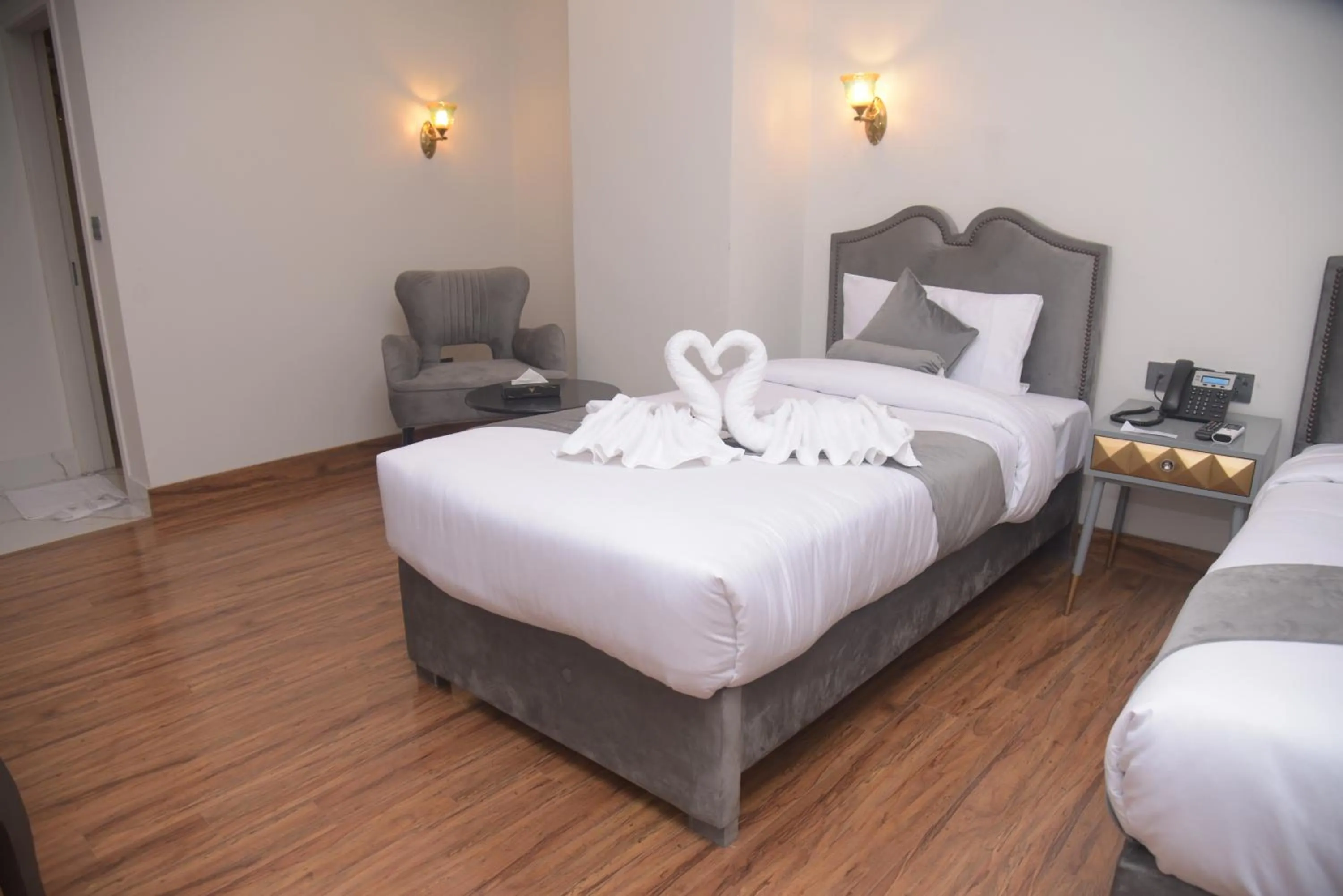 Bed in The Rich Hotel & Apartments