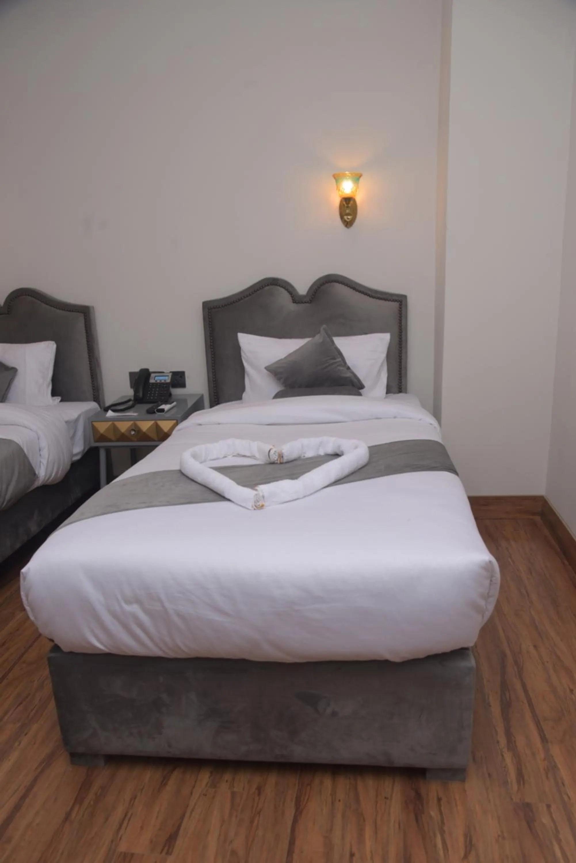 Bed in The Rich Hotel & Apartments